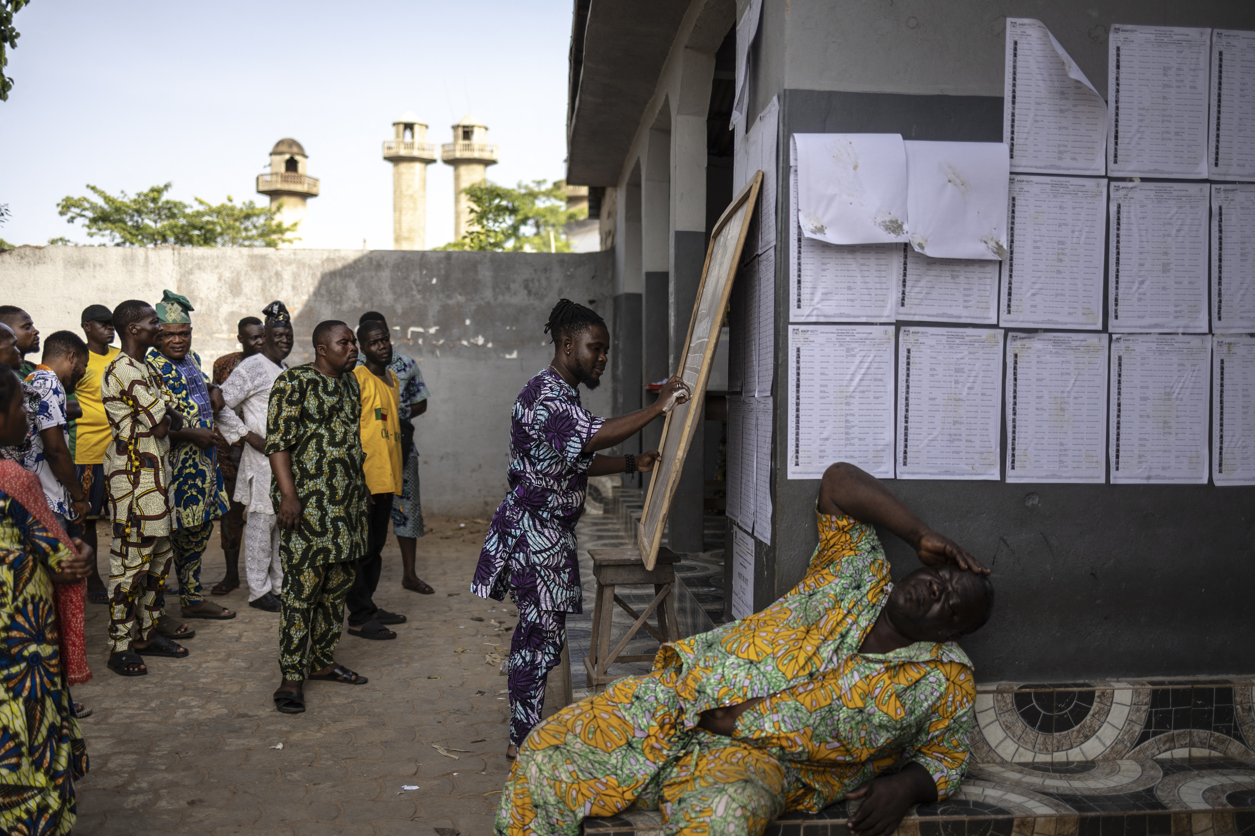 An electoral official writes the results on a board during vote counting at a polling station in Porto-Novo, on April 12, 2026 during Benin's presidential elections. (Photo by OLYMPIA DE MAISMONT / AFP)