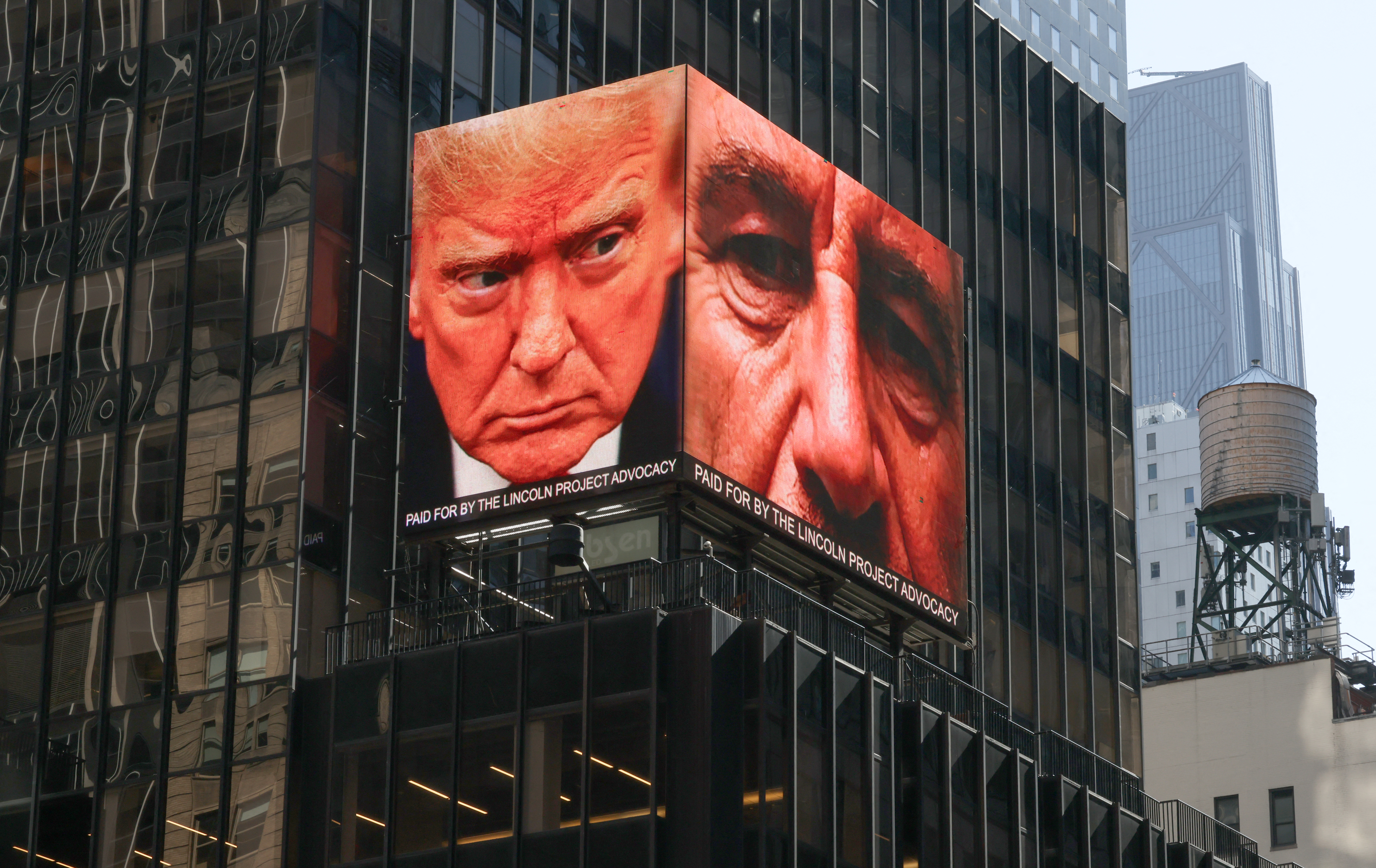 TOPSHOT - Images of US President Donald Trump and the late convicted sex offender Jeffrey Epstein are displayed on a digital billboard in Times Square in New York April 8, 2026.