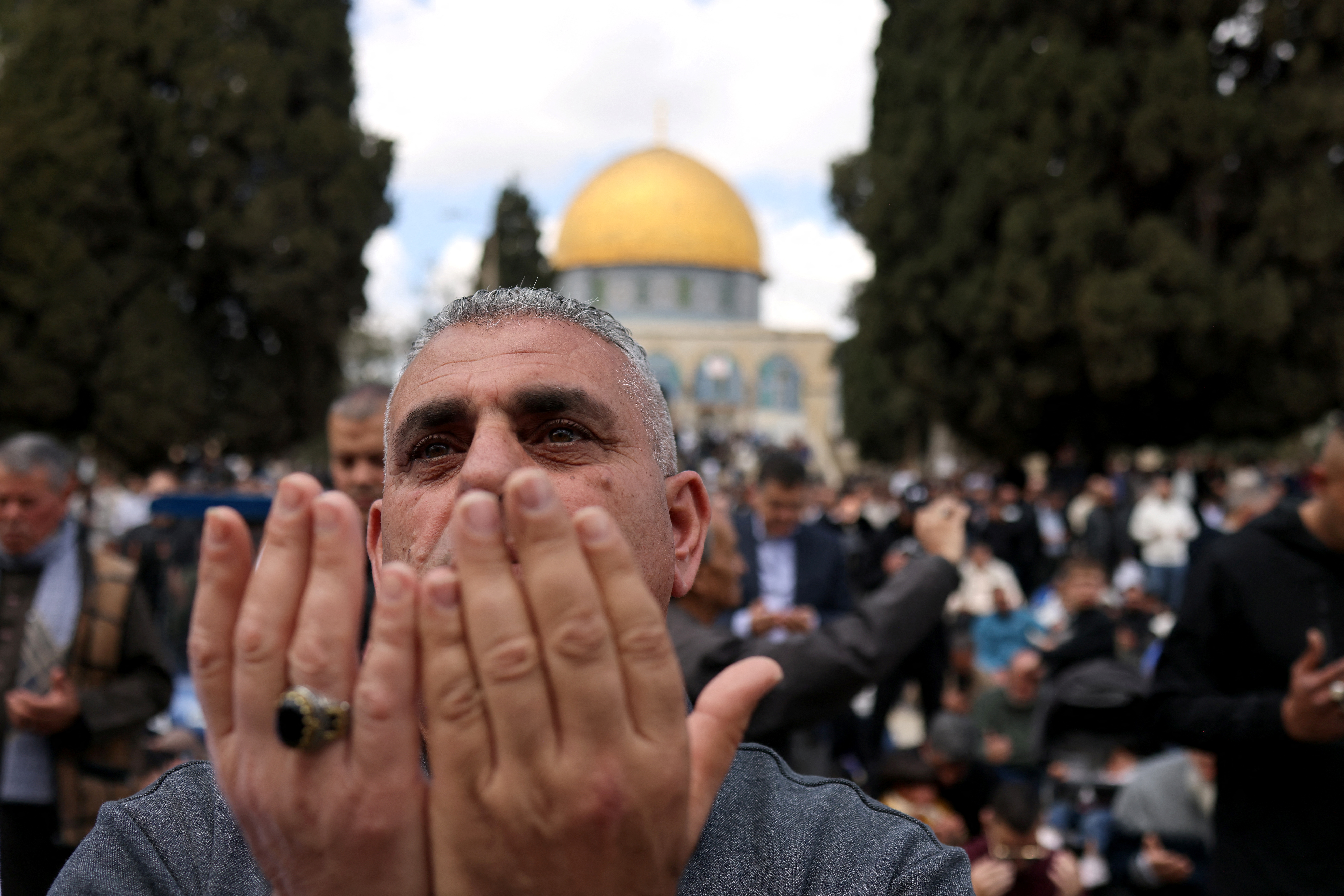 A Muslim man prays outside the Dome of the Rock at the Al-Aqsa Mosque compound.