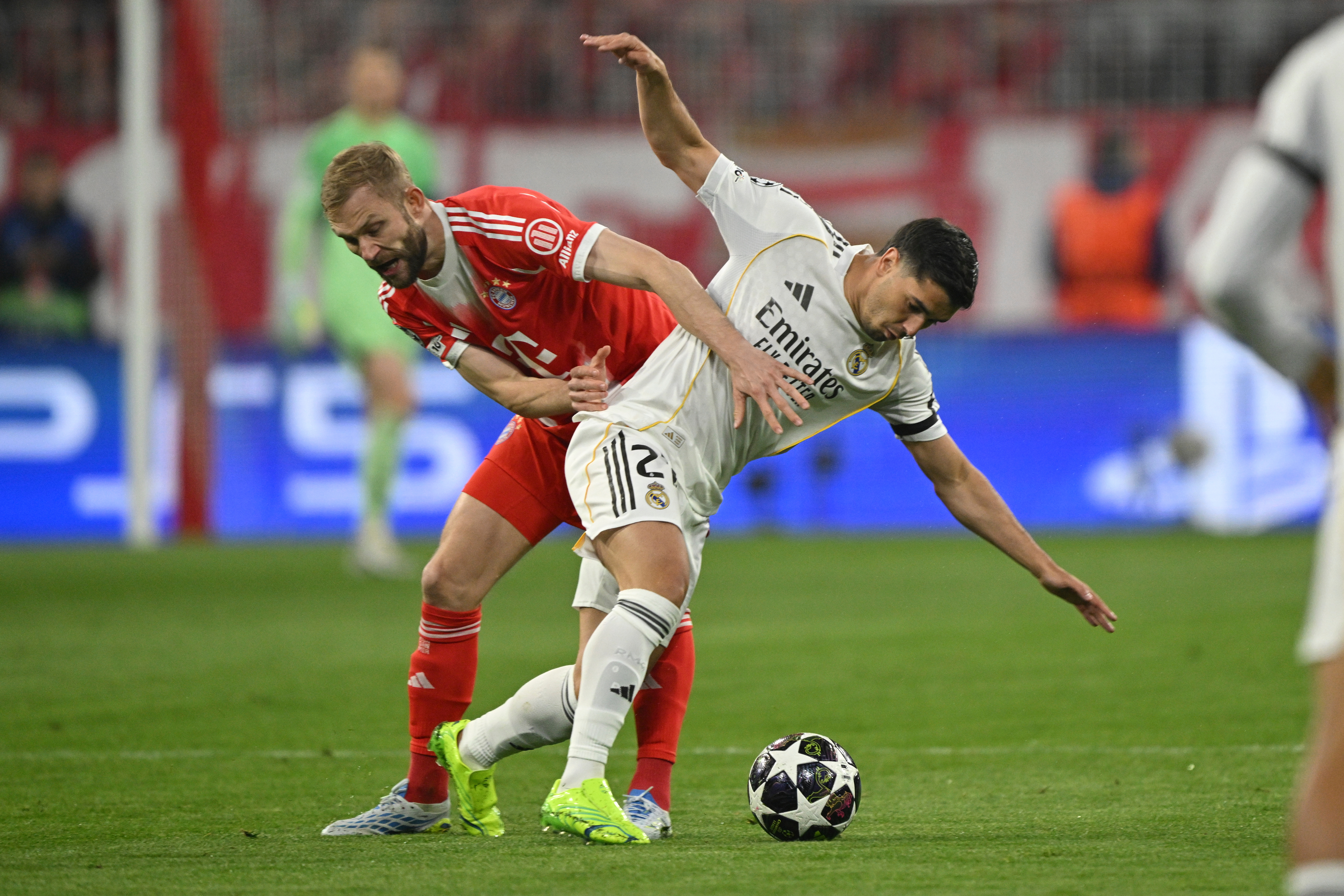 Real Madrid's Brahim Diaz challenges for the ball with Bayern's Konrad Laimer during the Champions League quarterfinal second leg soccer match between Bayern Munich and Real Madrid in Munich, Germany, Wednesday, April 15, 2026. (AP Photo/Lennart Preiss)