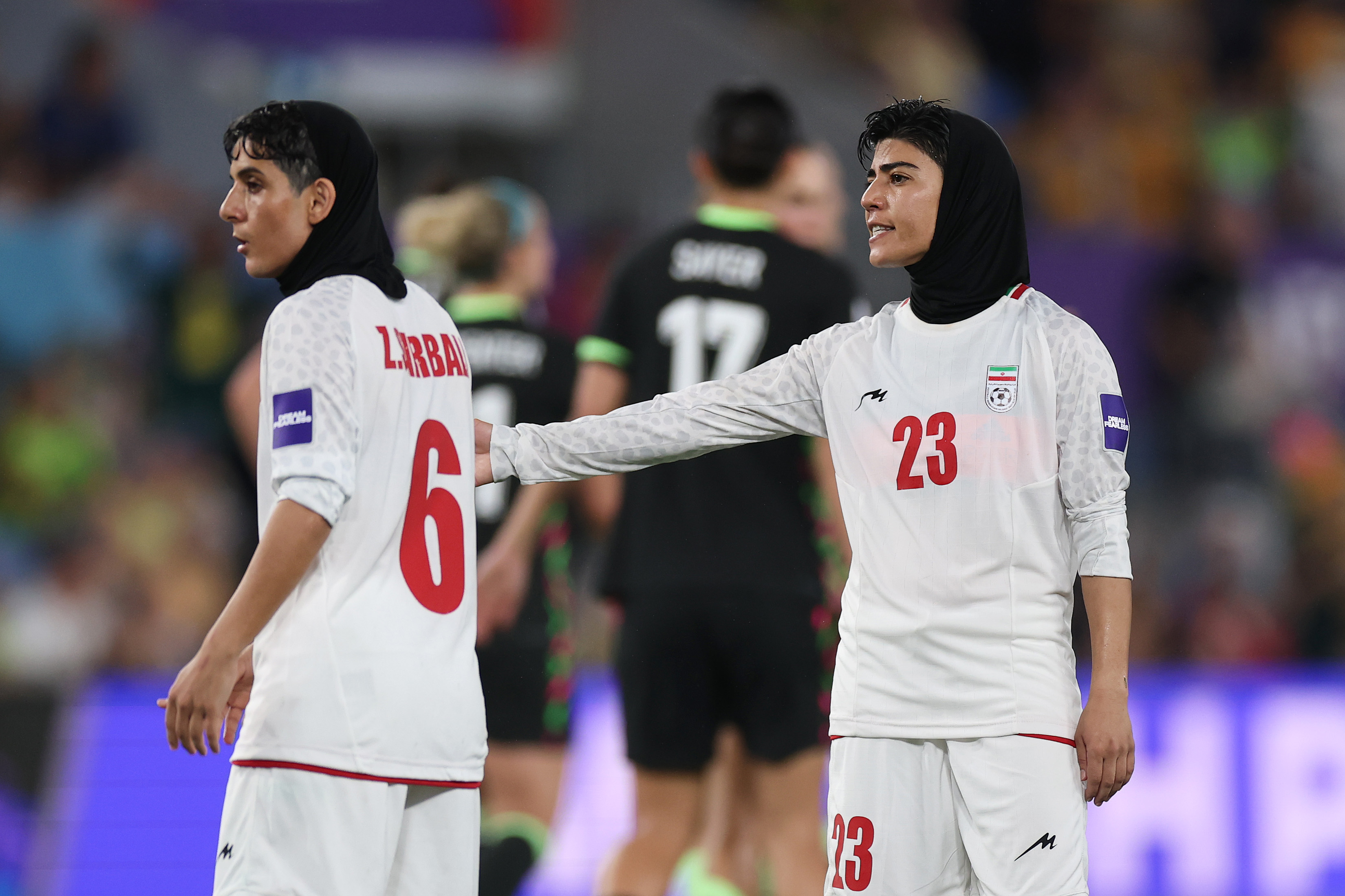 GOLD COAST, AUSTRALIA - MARCH 05: Mona Hamoudi and Zahra Sarbali of Islamic Republic of Iran react after Alanna Kennedy of Australia scores their teams third goal during the AFC Women's Asian Cup Australia 2026 match between Islamic Republic of Iran and Australia Matildas at Gold Coast Stadium on March 05, 2026 in Gold Coast, Australia. (Photo by Cameron Spencer/Getty Images)