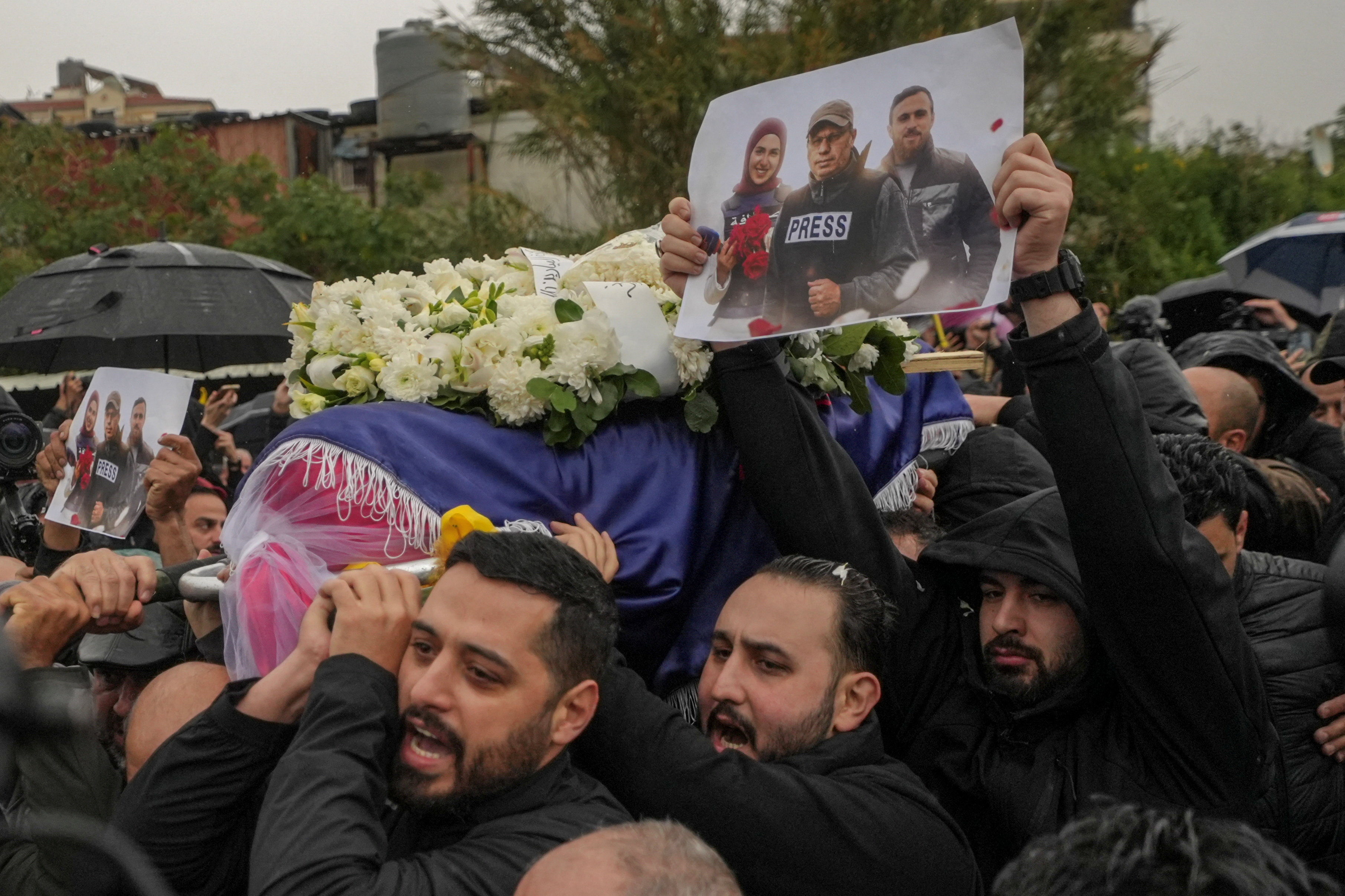 Relatives and friends carry the coffin of Mohammed Ftouni, during the funeral of Lebanese journalists, Al Mayadeen reporter Fatima Ftouni, cameraman Mohammed Ftouni and Al Manar reporter Ali Shaib, who were killed by a targeted Israeli strike, amid escalating hostilities between Israel and Hezbollah, as the U.S.-Israeli conflict with Iran continues, in Choueifat, Lebanon, March 29, 2026. REUTERS/Mohammad Yassine