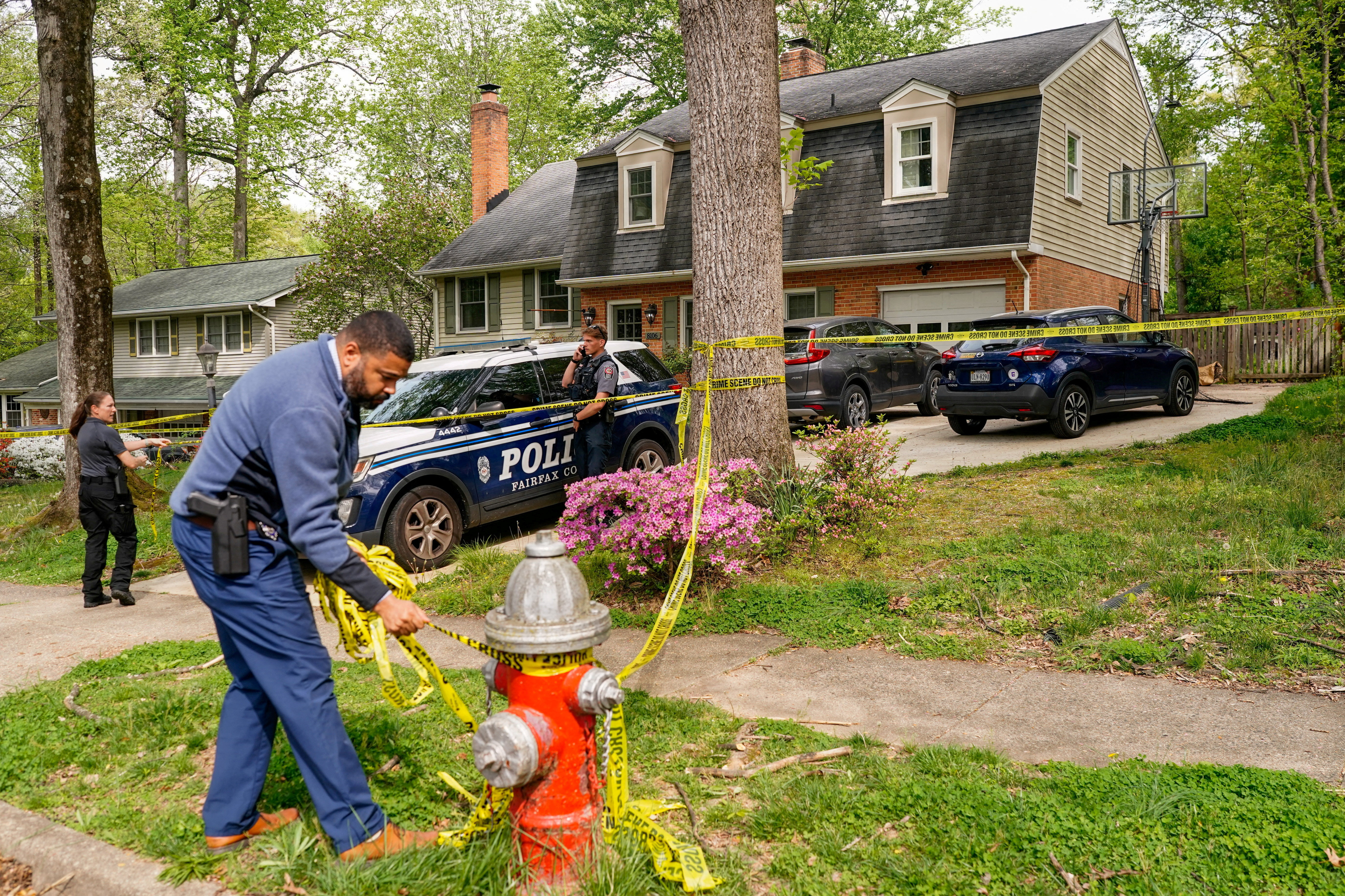 A police officer puts cordon tape on a hydrant outside the home of former Virginia Lieutenant Governor Justin Fairfax, after he shot and killed his wife Cerina Fairfax and himself, according to police, in Annandale, Virginia, U.S, April 16, 2026. REUTERS/Nathan Howard TPX IMAGES OF THE DAY