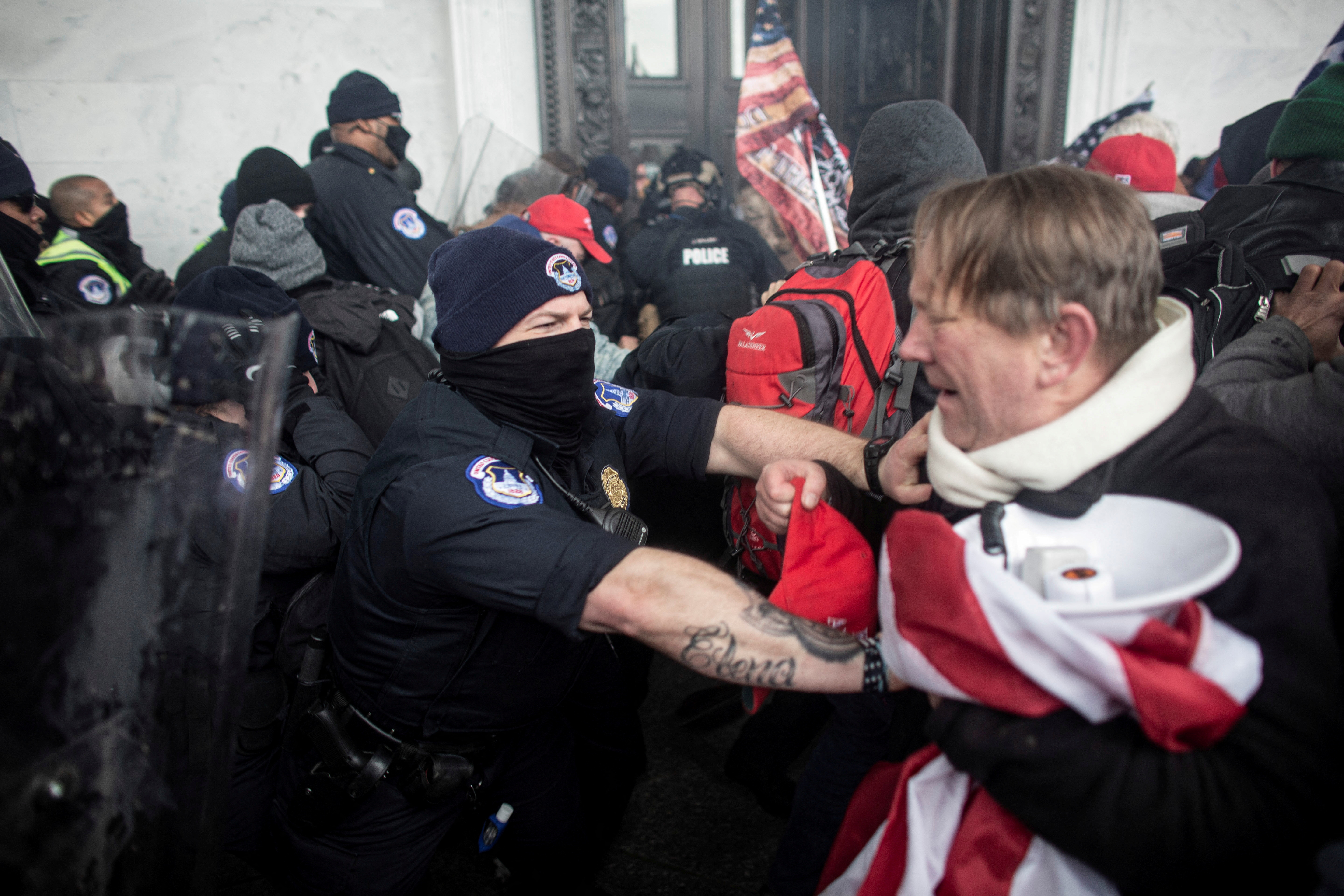 FILE PHOTO: Members of law enforcement clash with pro-Trump protesters, who stormed the U.S. Capitol during a rally to contest the certification of the 2020 U.S. presidential election results by the U.S. Congress, at the U.S. Capitol Building in Washington, D.C., U.S. January 6, 2021. Picture taken January 6, 2021. REUTERS/Ahmed Gaber./File Photo