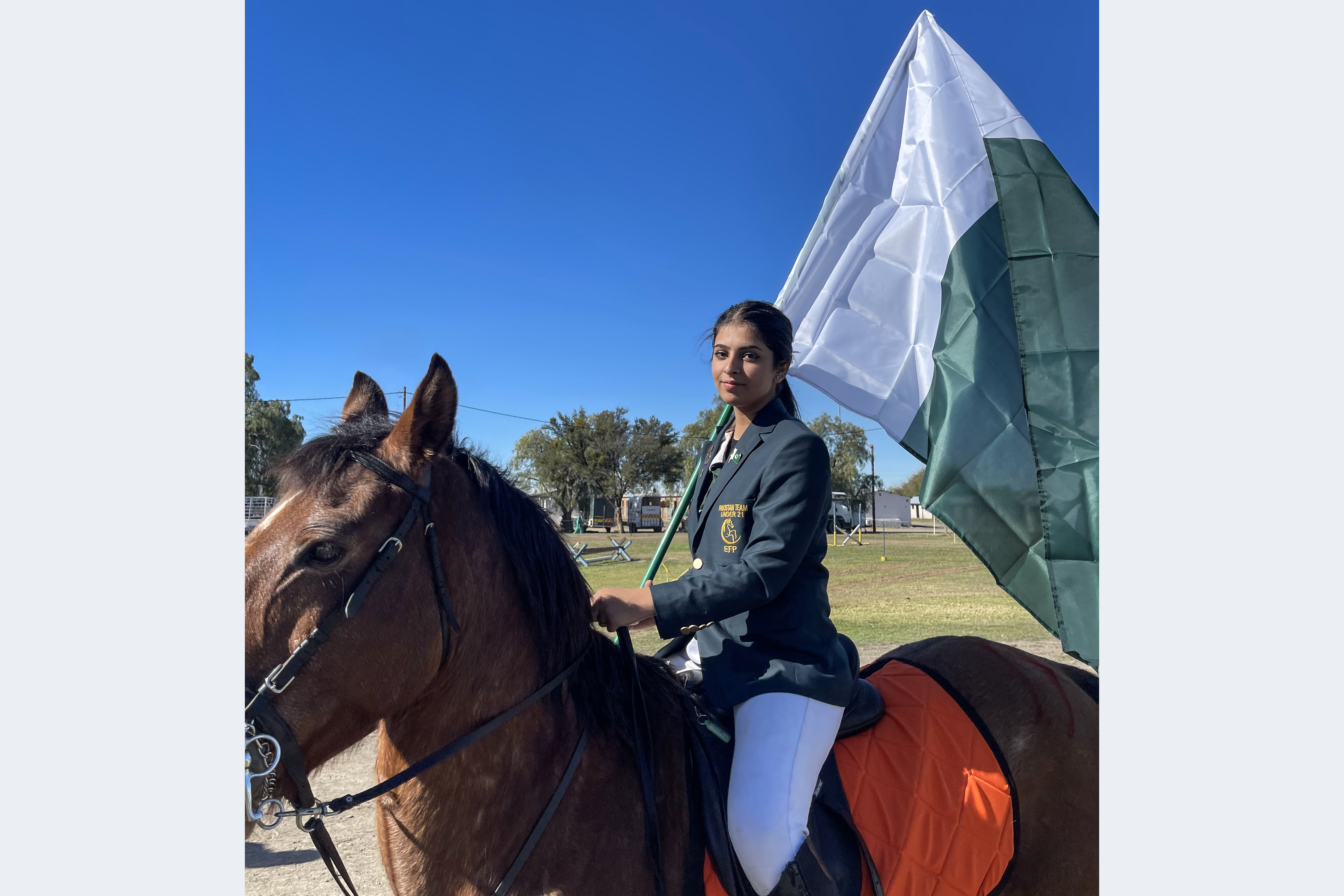 Ayesha Khan proudly holding Pakistan’s flag in South Africa at the Under-21 World Tent Pegging Championship 2023, the only girl in a team of four boys
