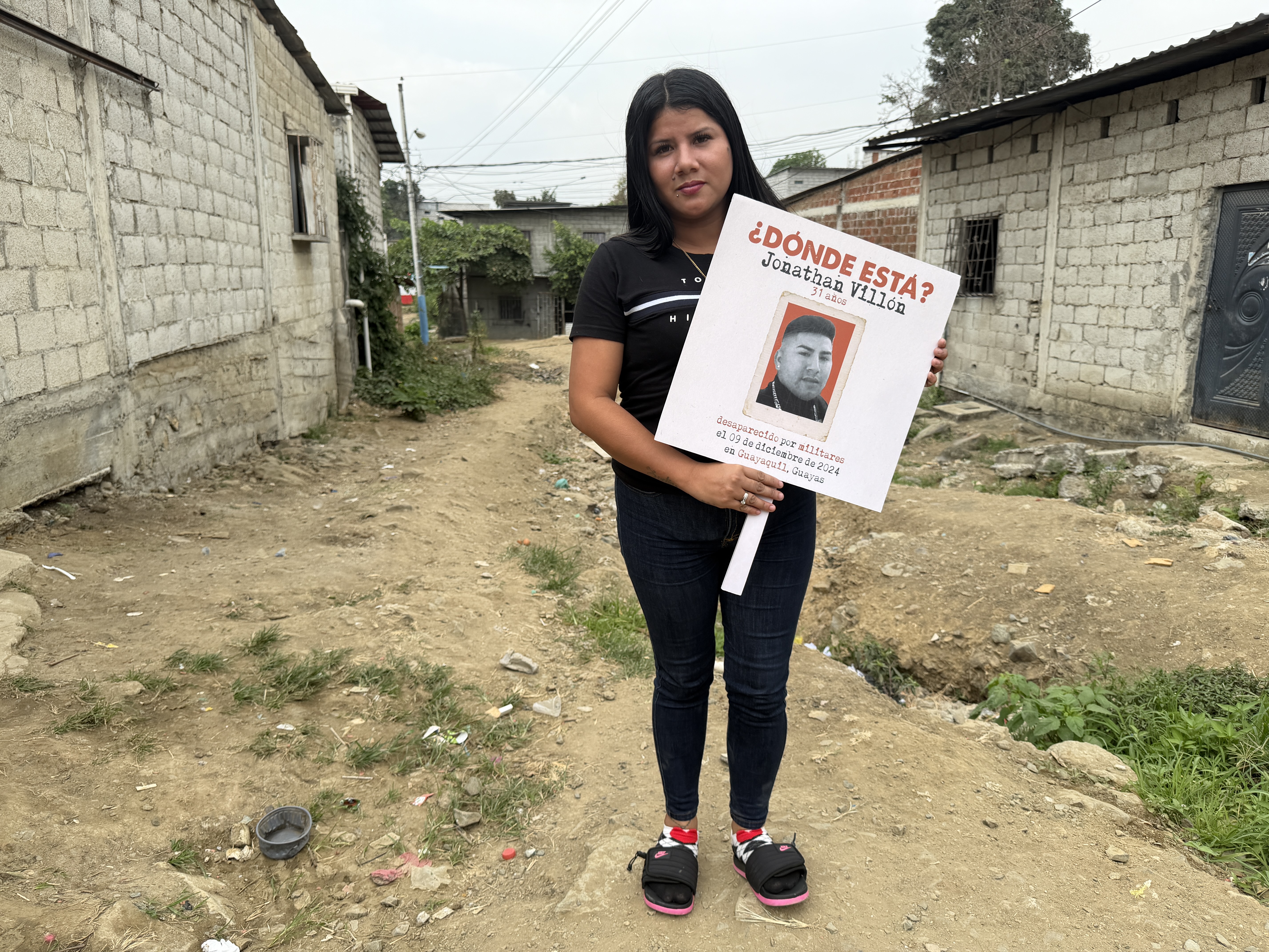 Rosario Villon with a picket sign, asking about the whereabouts of her brother, Jonathan