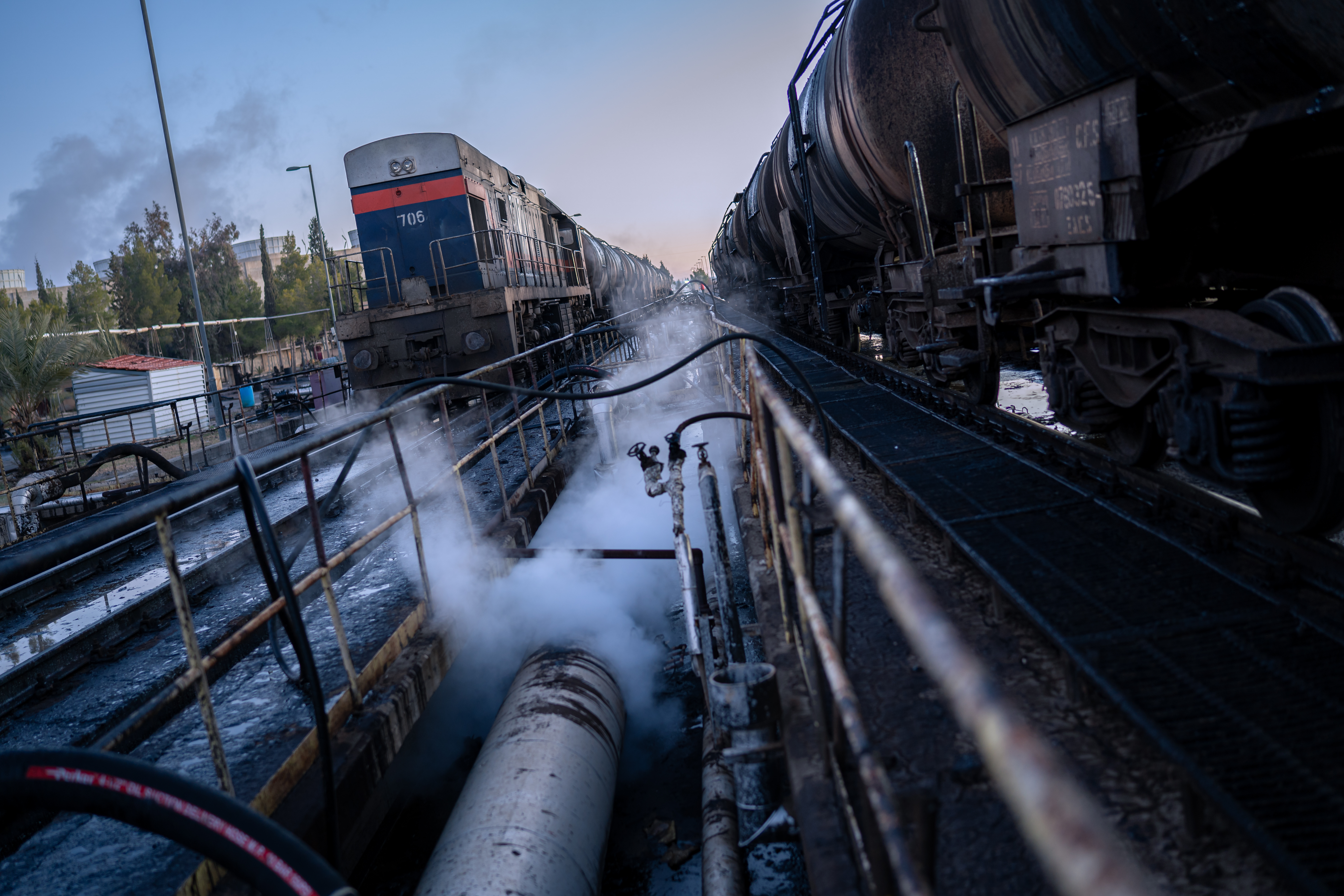 Fuel is unloaded from a Syrian Railways freight train at the Aleppo Thermal Power Plant [Charles Cuau/Al Jazeera]