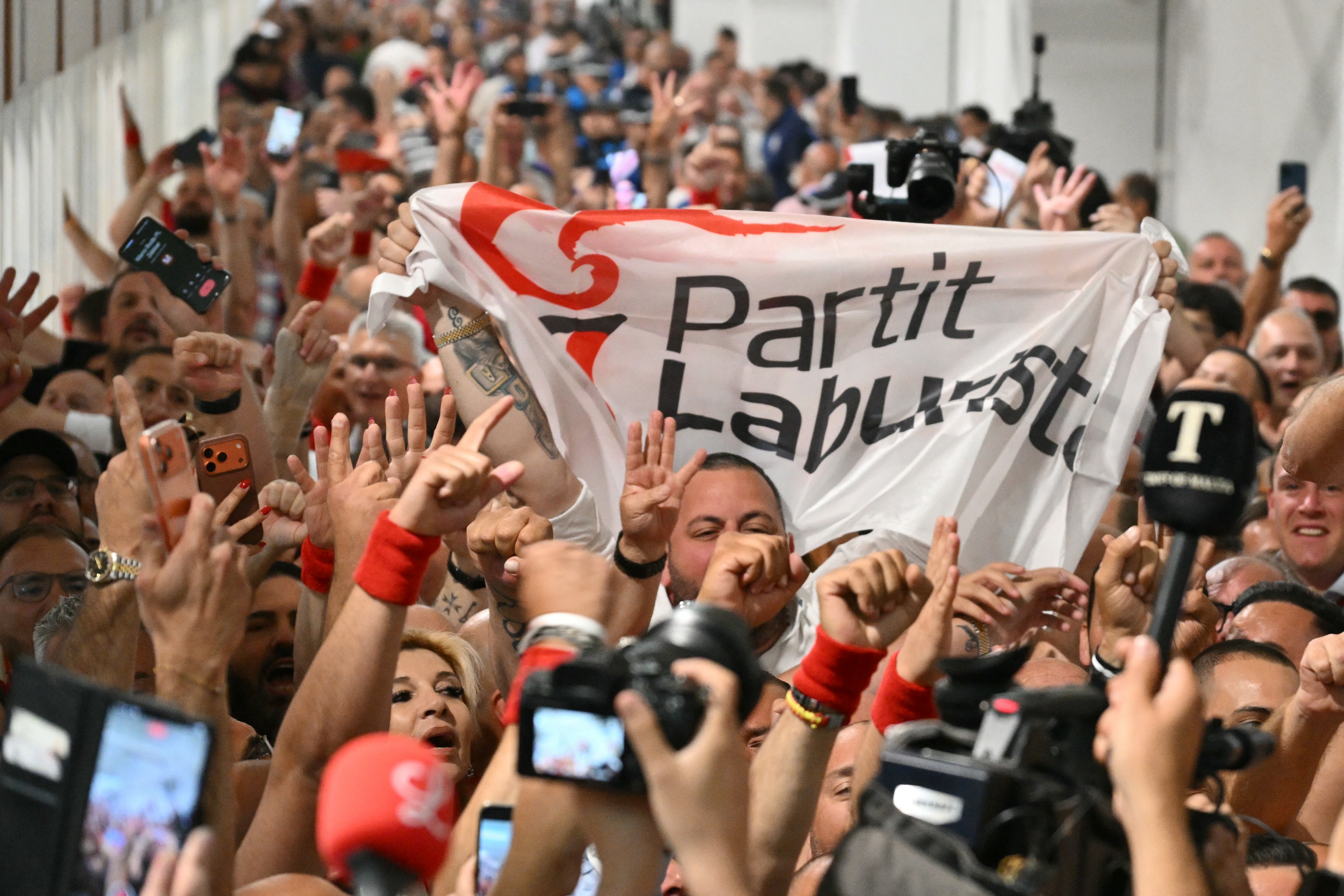 Members of the Labour Party react at the counting hall in Naxxar, on the island of Malta