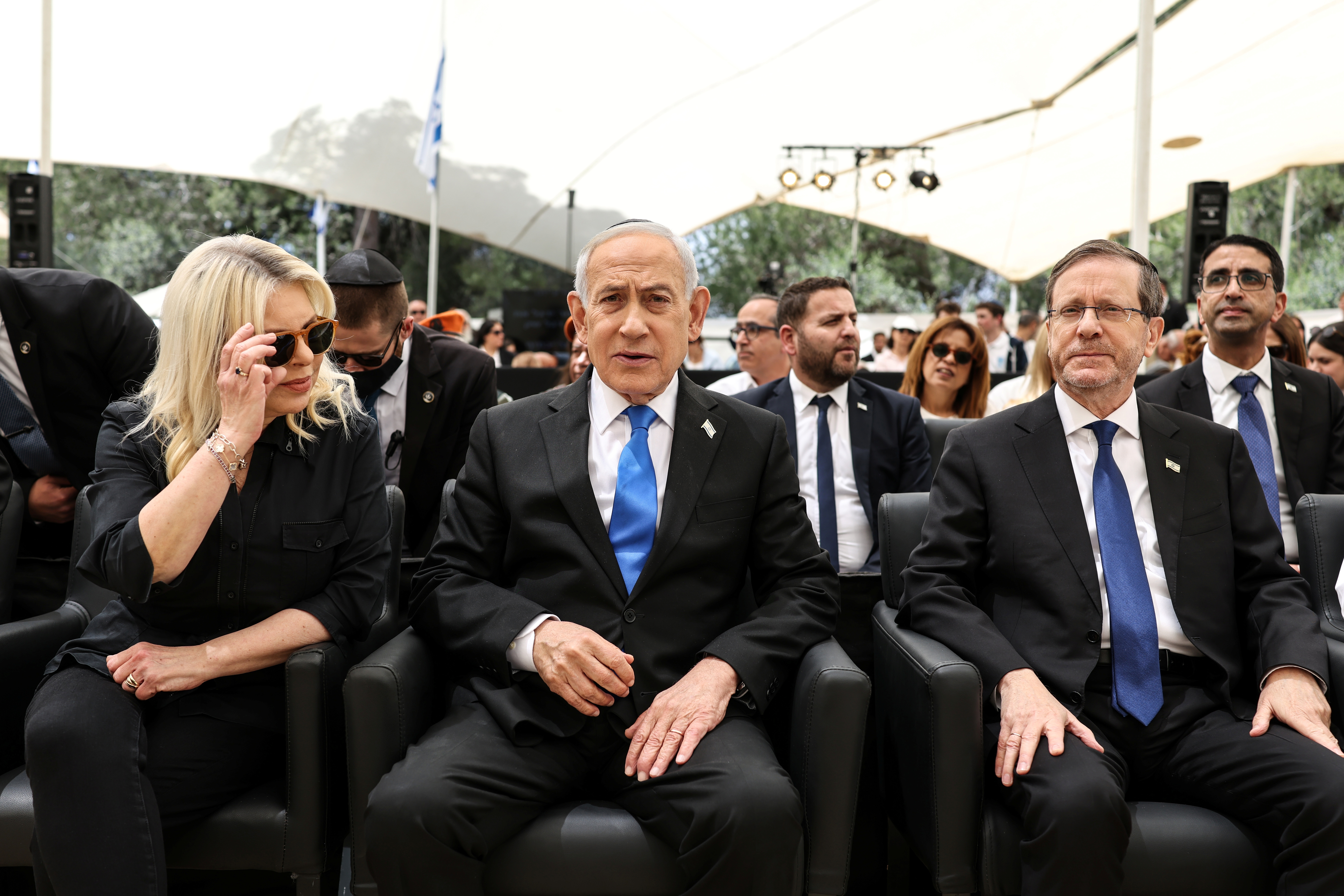 Israel's Prime Minister Benjamin Netanyahu, centre, and his wife Sara, left, and Israel's President Isaac Herzog attend a ceremony commemorating Israel's Remembrance Day for fallen soldiers, or Yom HaZikaron, at the Military Cemetery on Mount Herzl in Jerusalem, Tuesday April 21, 2026. (Ilia Yefimovich/Pool Photo via AP)