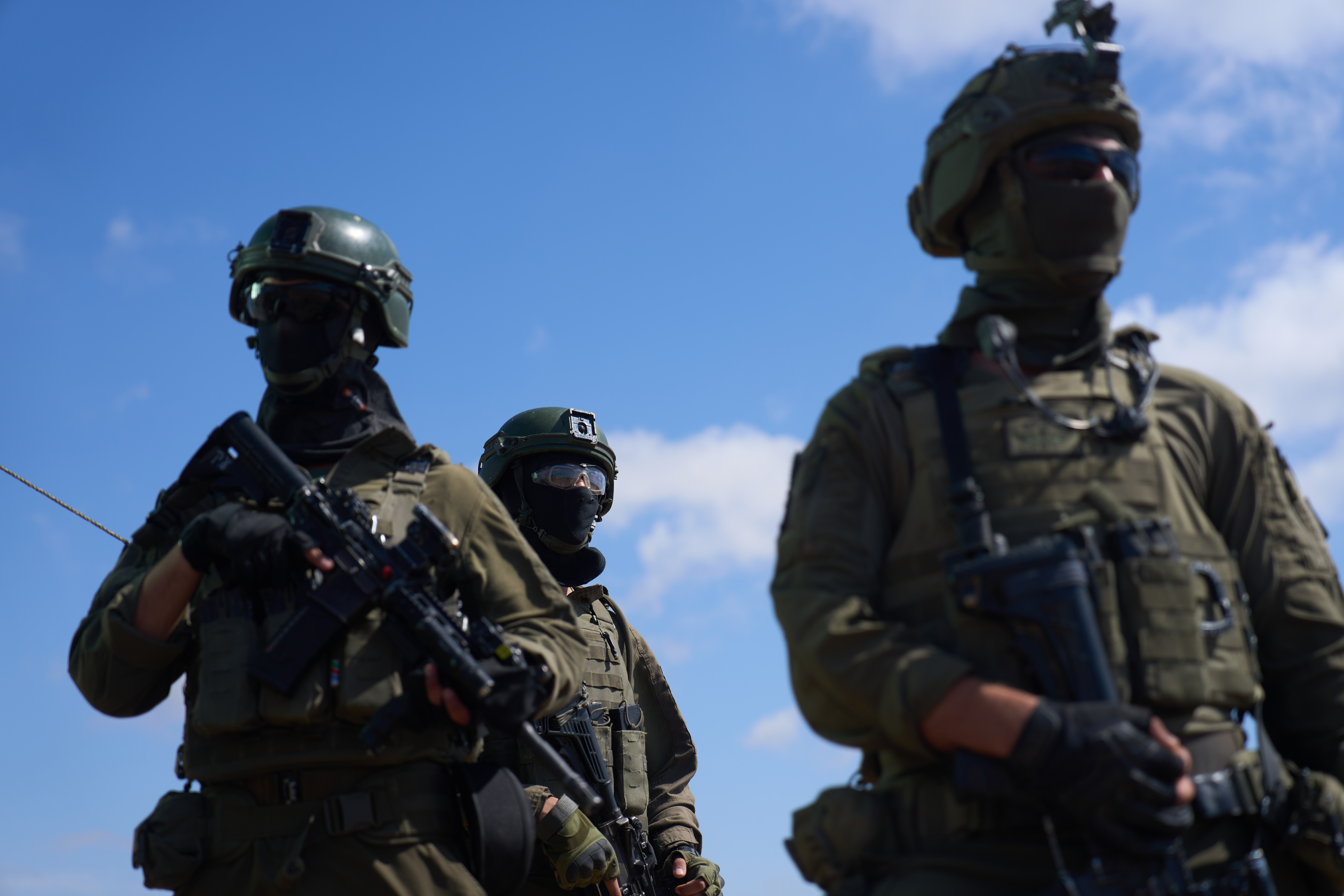 Armed soldiers stand outside