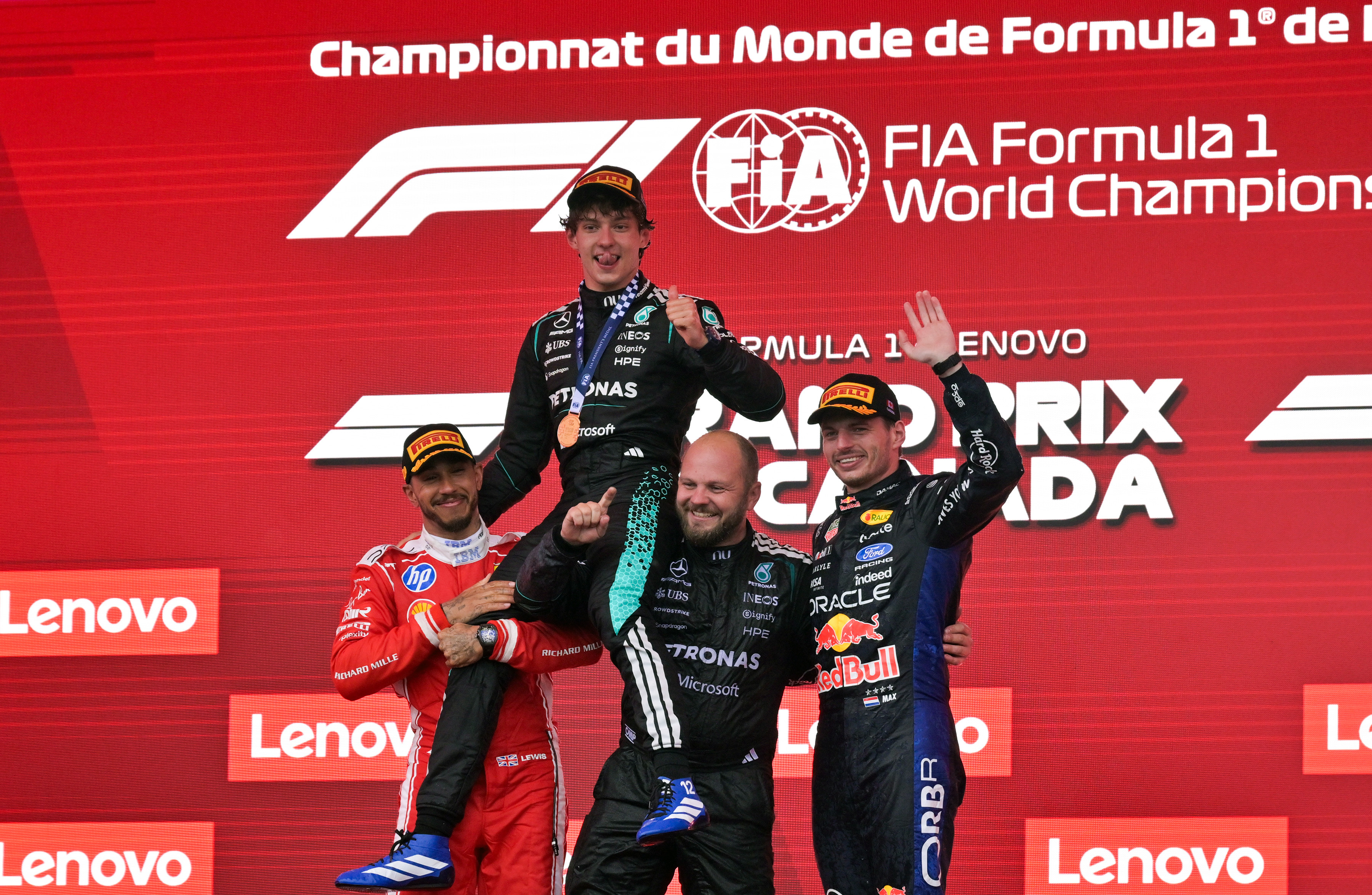 May 24, 2026; Montreal, Quebec, CANADA; Ferrari driver Lewis Hamilton (44) and Mercedes driver Kimi Antonelli (12) and Red Bull Racing driver Max Verstappen (3) on the podium during the Lenovo Grand Prix Du Canada at Circuit Gilles-Villeneuve.Antonelli won. Mandatory Credit: Eric Bolte-Imagn Images