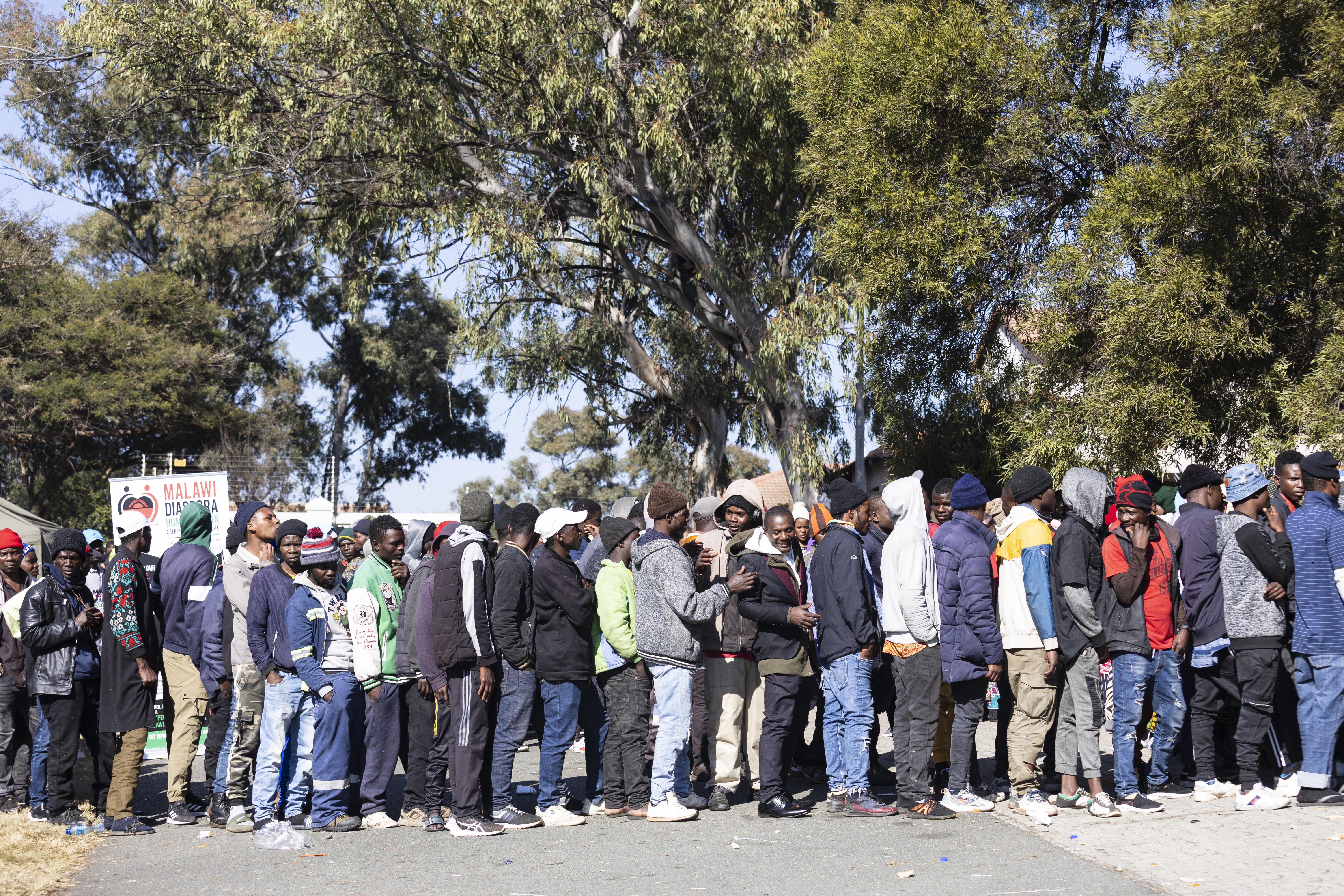 Malawian refugees gather outside their embassy as they try to get buses back to their home country on June 29, 2026
