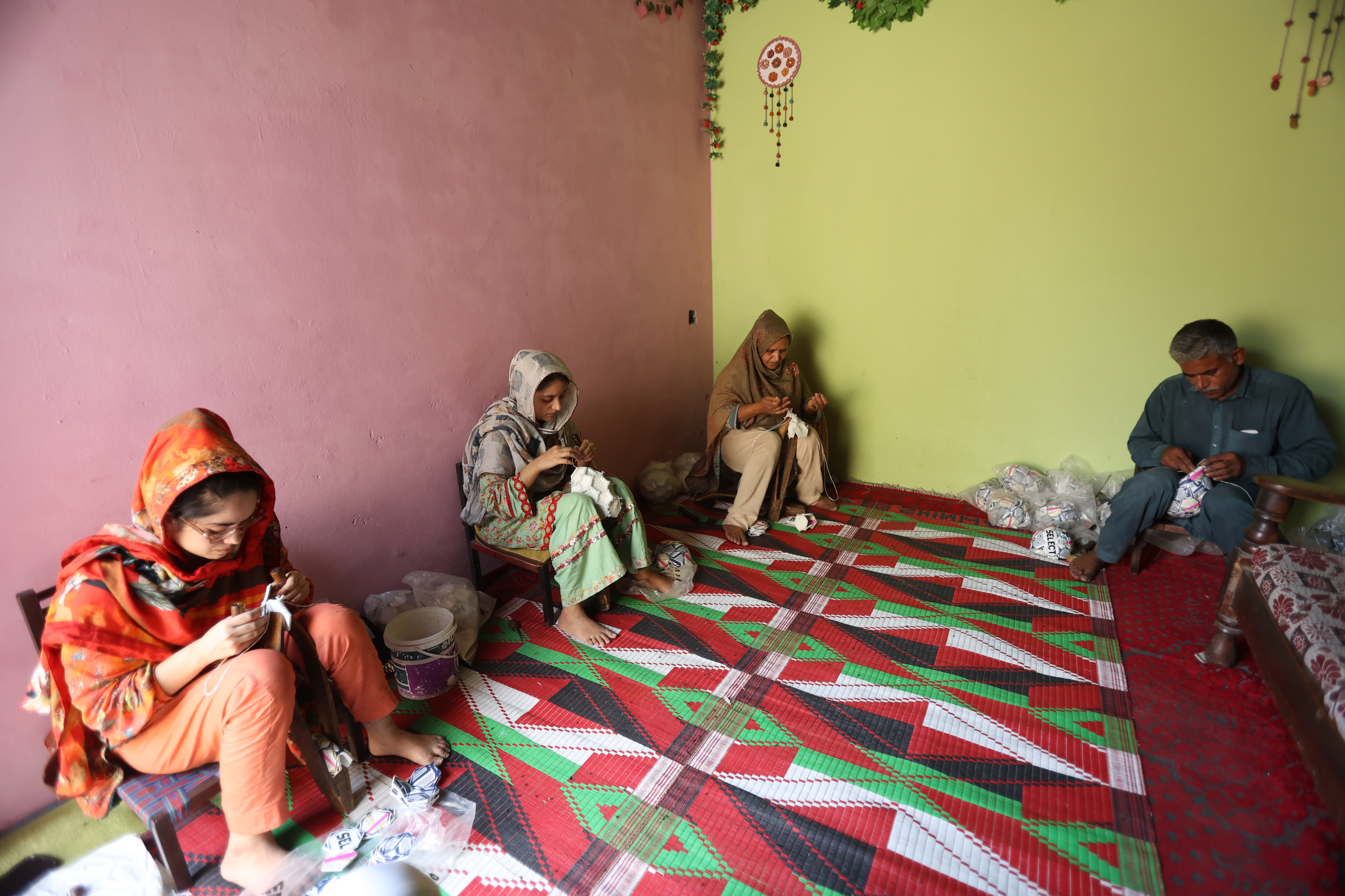Abida Hussain and her family stitch footballs