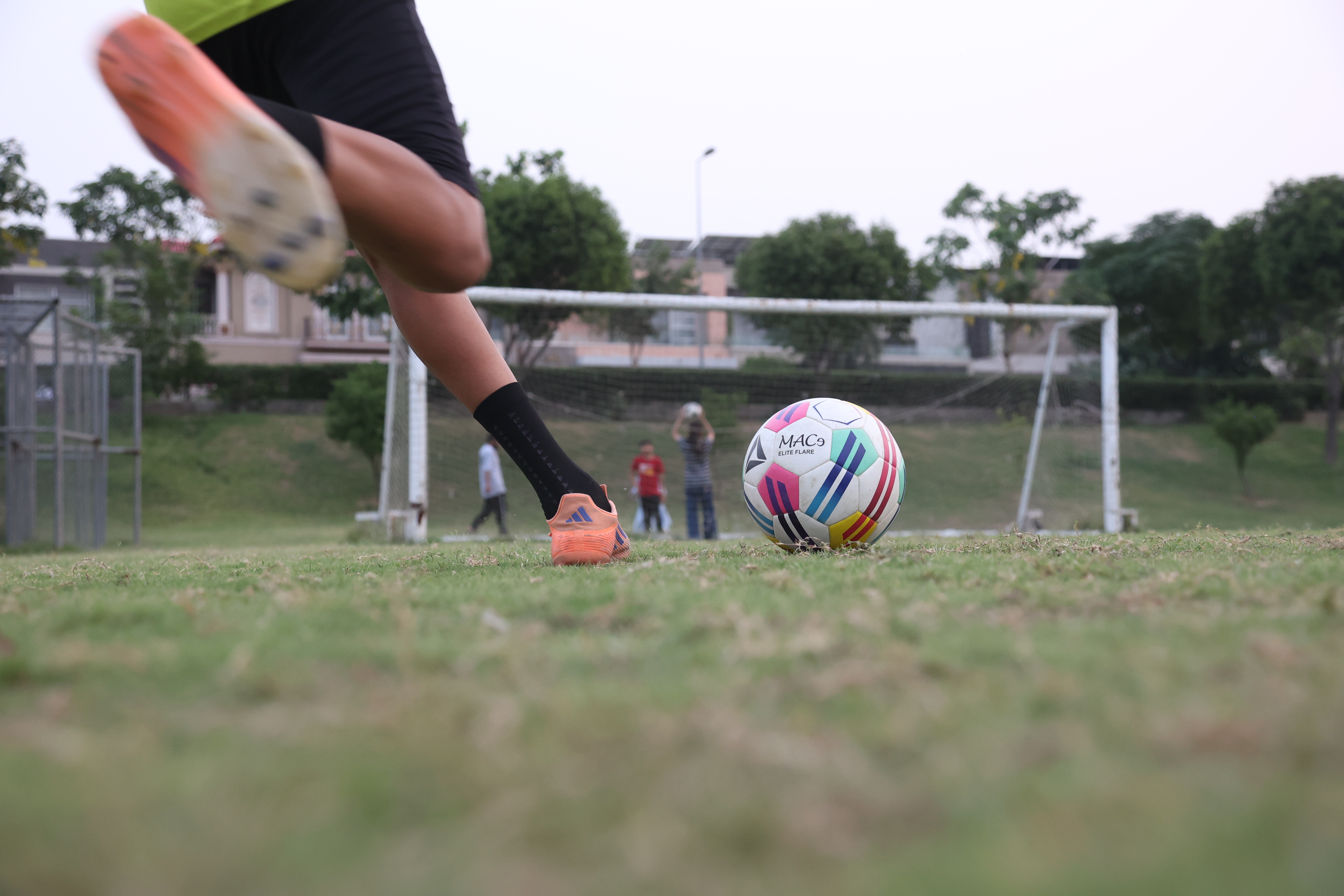 A child in Sialkot, Pakistan kicks a locally stitched football