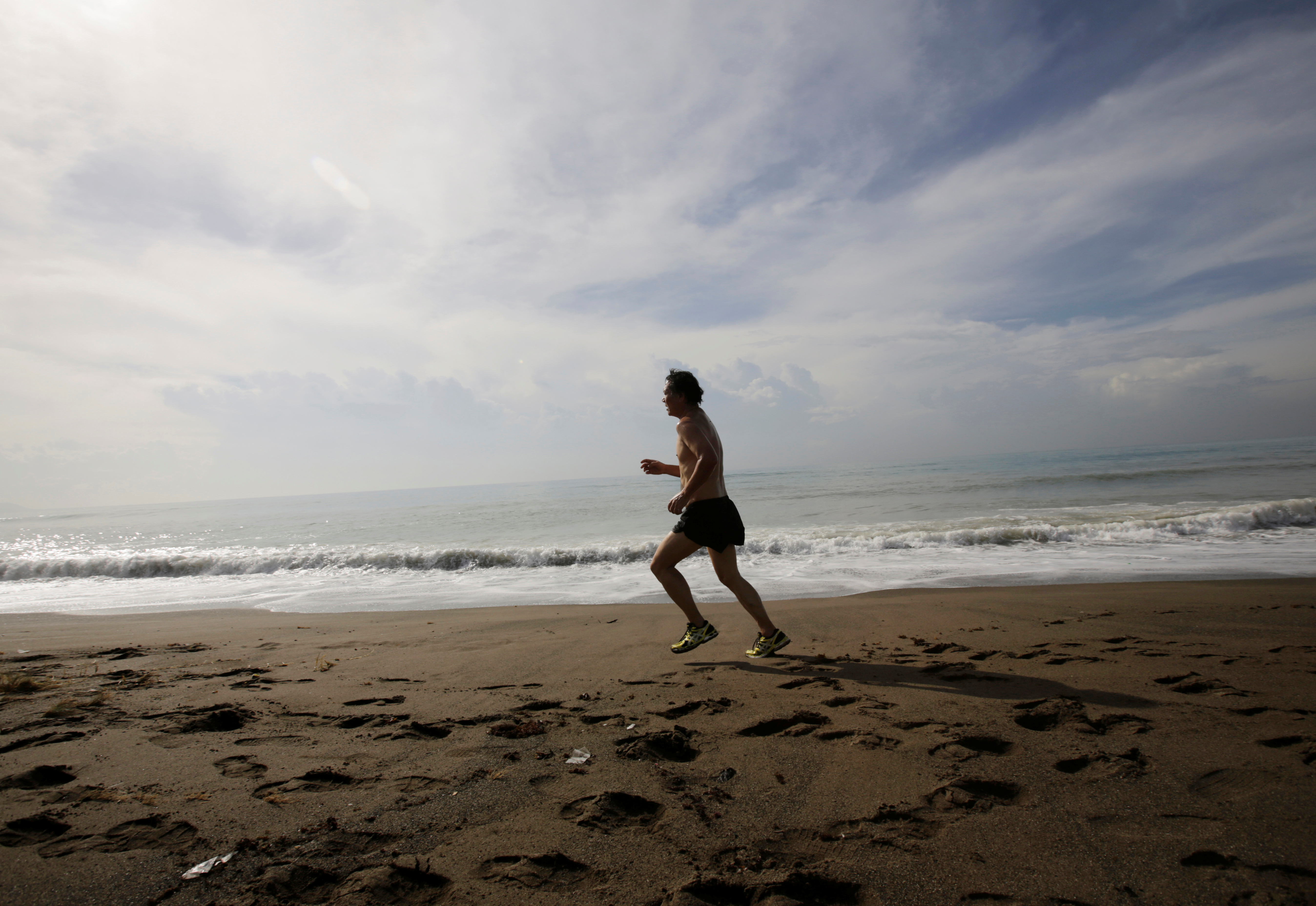 A man runs on the beach