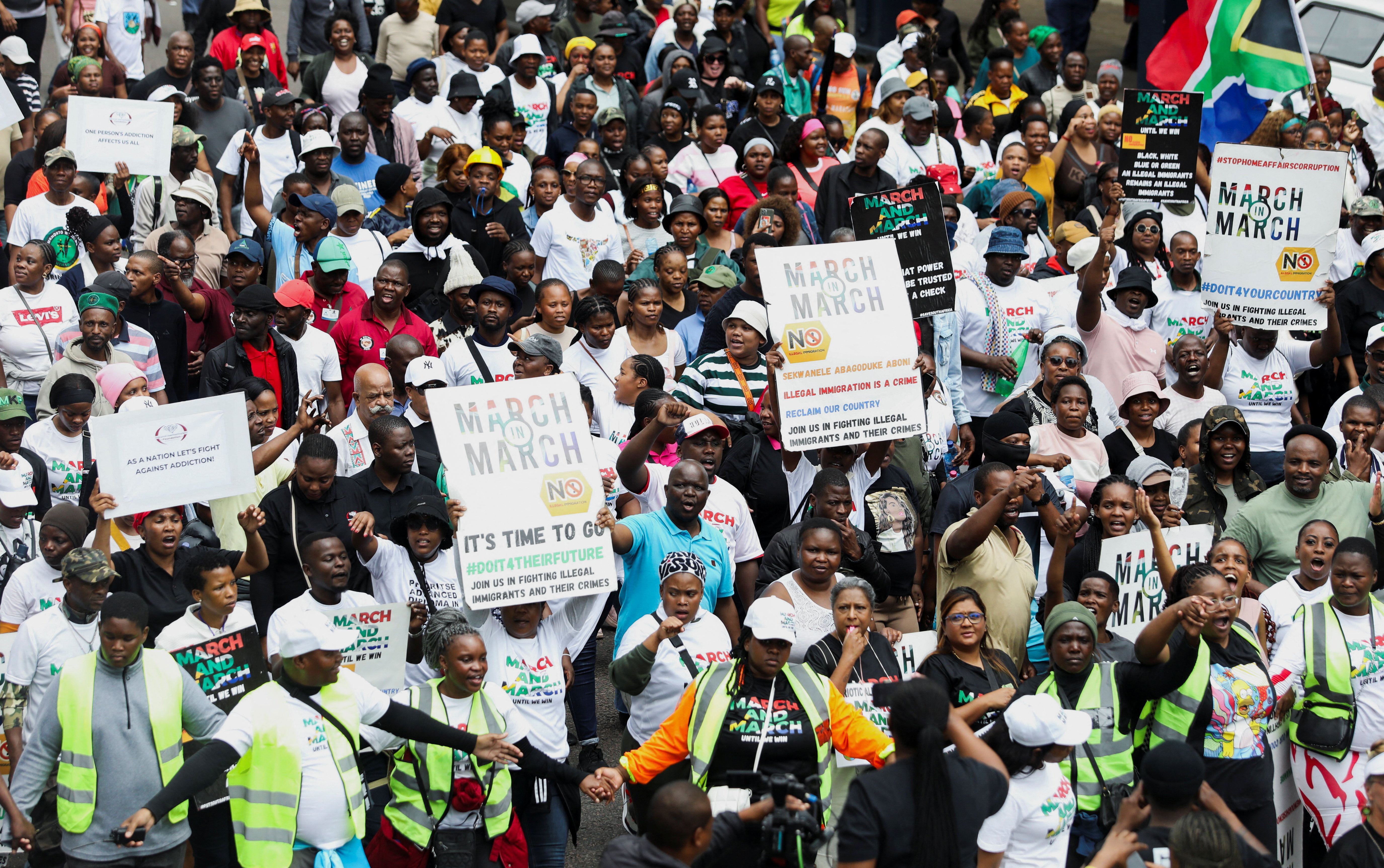 Protesters hold placards during an anti-immigration march in Durban, South Africa, calling for tighter border controls and the deportation of undocumented migrants [Thuli Dlamini/Reuters]