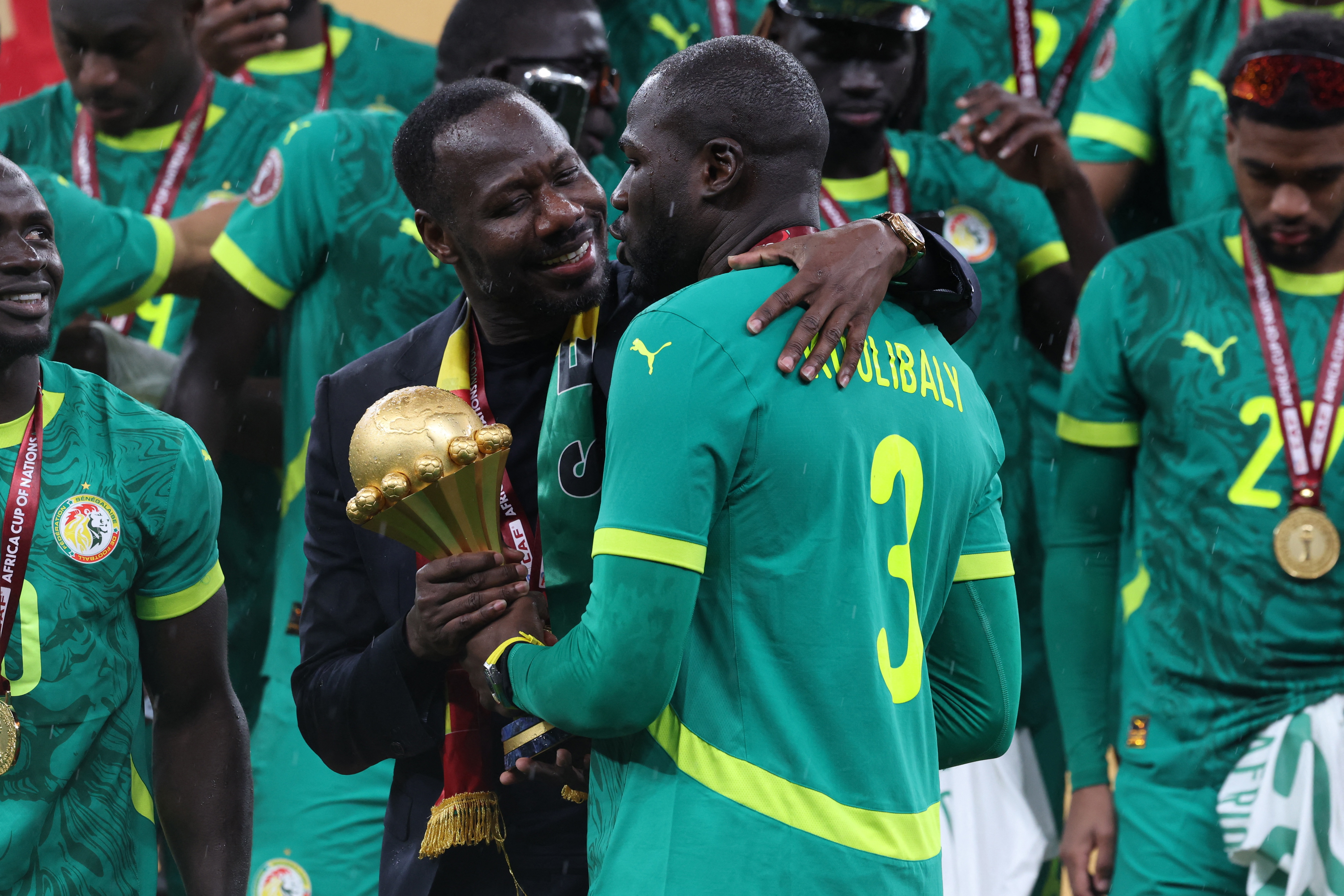 Senegal coach Pape Thiaw and Kalidou Koulibaly celebrate with the trophy after the Africa Cup of Nations Final in Morocco in January