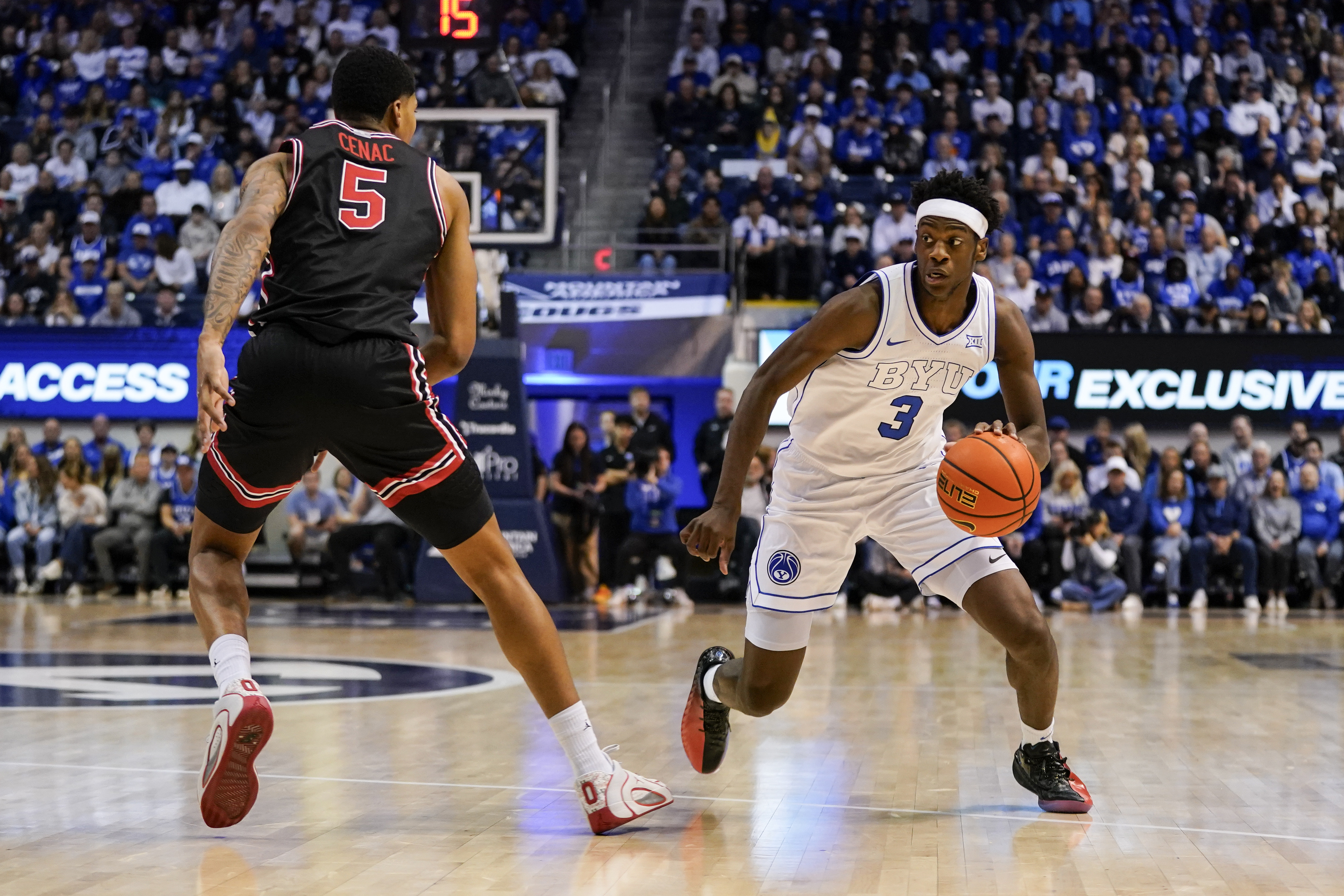 Feb 7, 2026; Provo, Utah, USA; BYU Cougars forward AJ Dybantsa (3) controls the ball while being defended by Houston Cougars forward Chris Cenac Jr. (5) during the first half at Marriott Center. Mandatory Credit: Aaron Baker-Imagn Images
