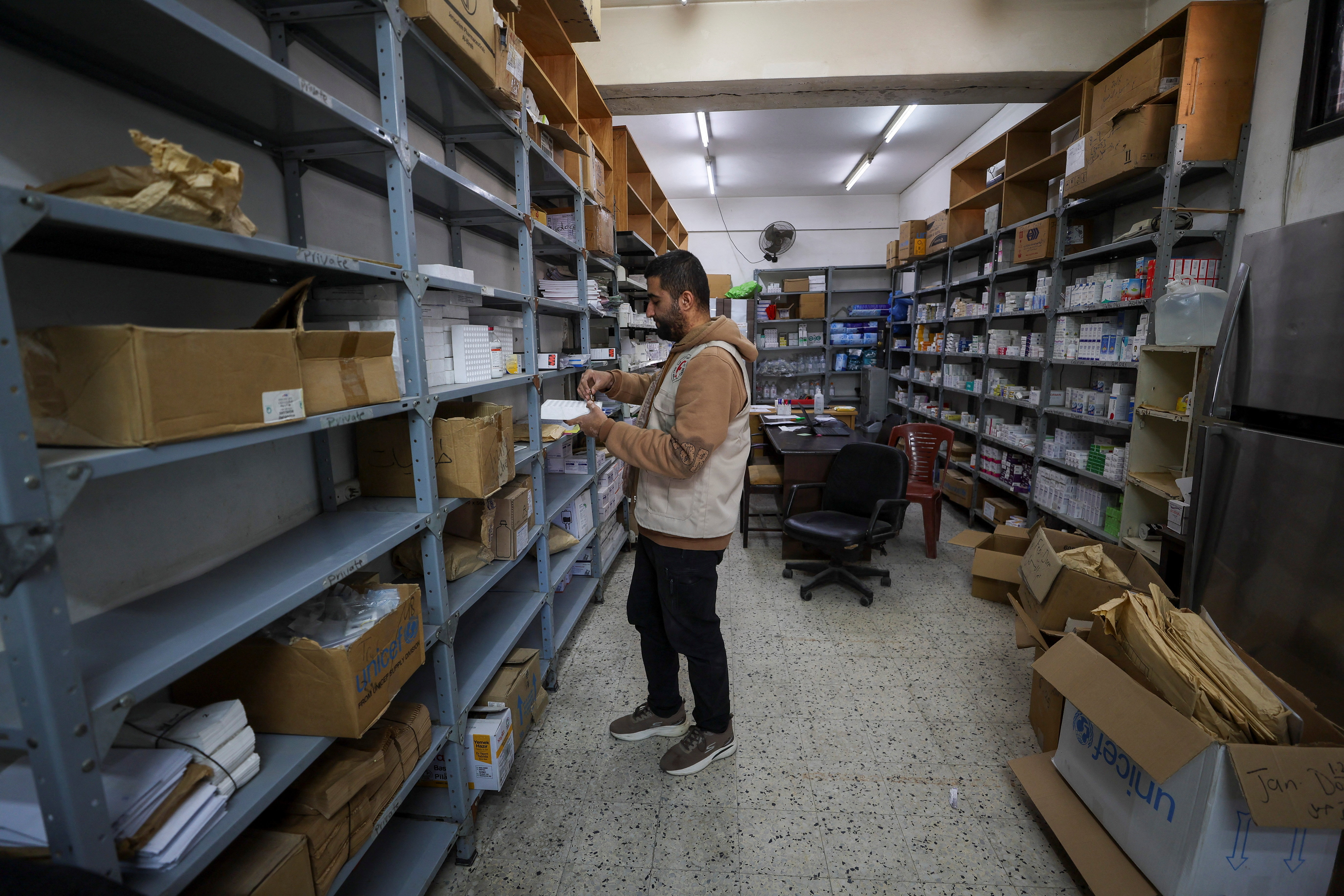 A Palestinian pharmacist handles medicine as medical supplies run critically low, according to the World Health Organization, at Al-Ahli Arab Hospital in Gaza City, March 8, 2026