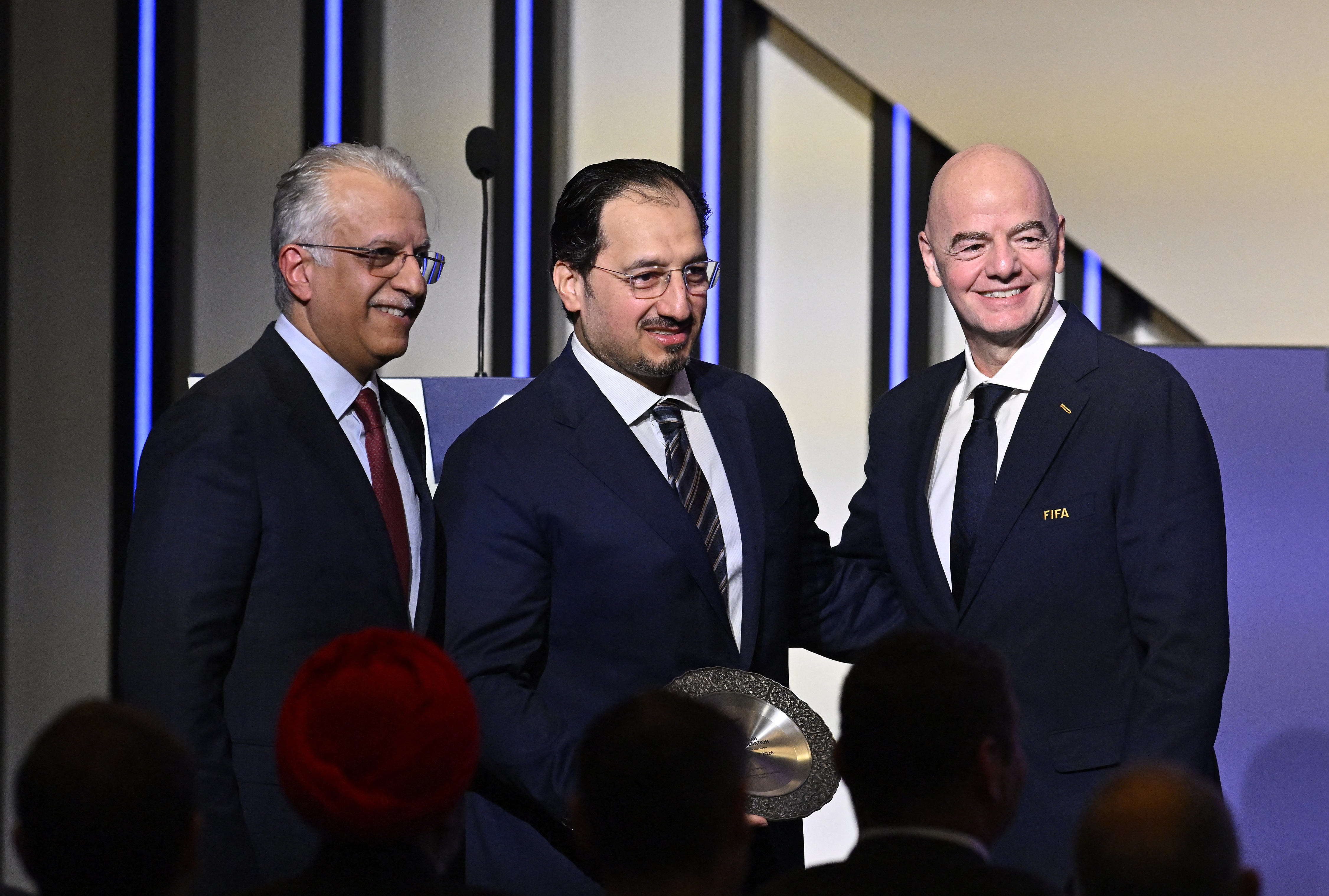 Soccer Football - 36th AFC Annual Congress - Vancouver Convention Centre, Vancouver, Canada - April 28, 2026 Senior Vice-president of the FIFA Council, Salman bin Ibrahim Al Khalifa, President of the Saudi Arabian Football Federation and FIFA council members Yasser Al Misehal and FIFA president Gianni Infantino pose during the congress REUTERS/Jennifer Gauthier
