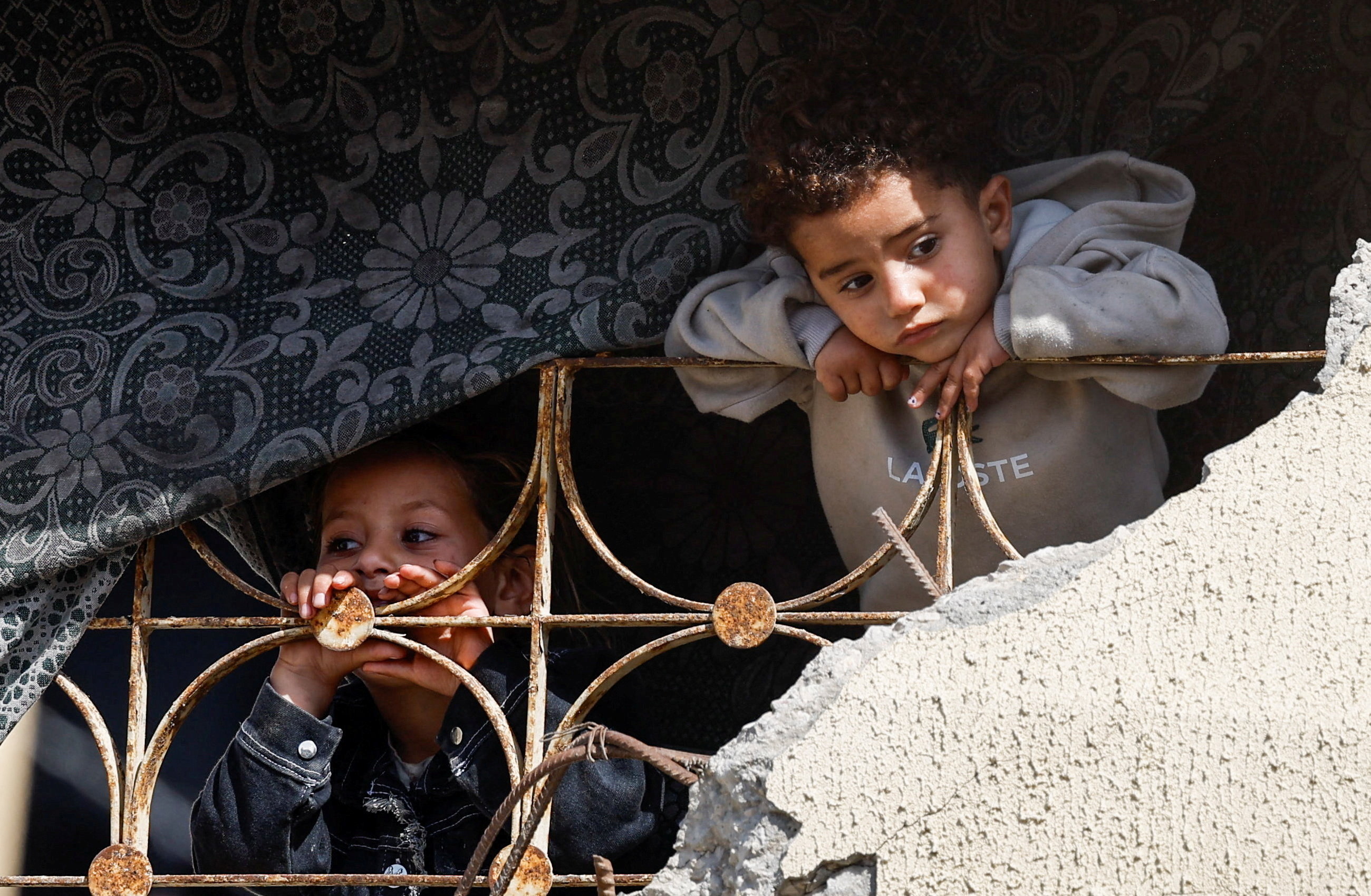 Children look on as Palestinians attend a mass wedding for 50 couples organized by the IHH Humanitarian Relief Foundation in Gaza City, May 11, 2026