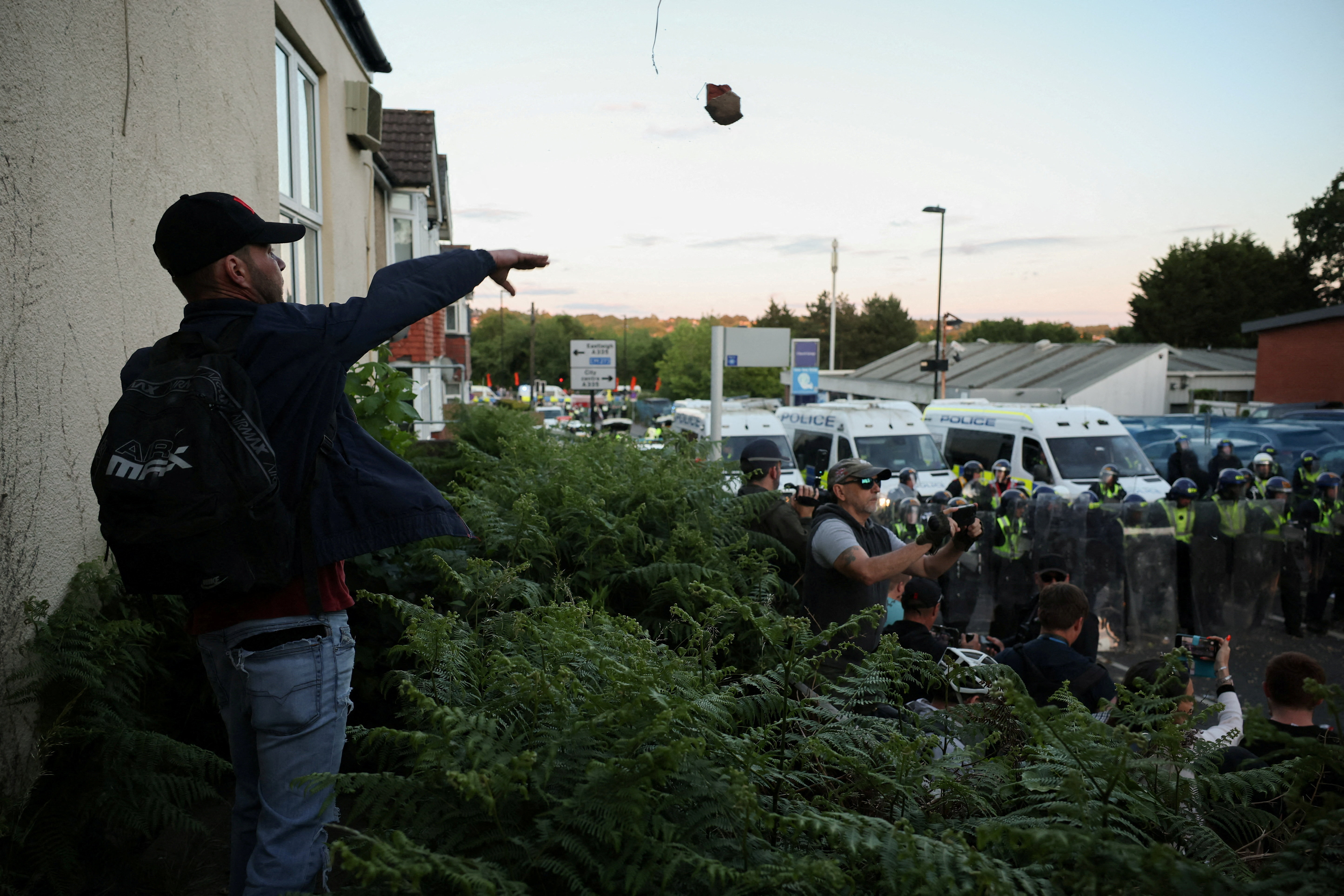 A protester throws a brick towards police officers during a demonstration following the conviction of Vikrum Digwa for the murder of student Henry Nowak, in Southampton, Britain, June 2, 2026. REUTERS/Isabel Infantes TPX IMAGES OF THE DAY