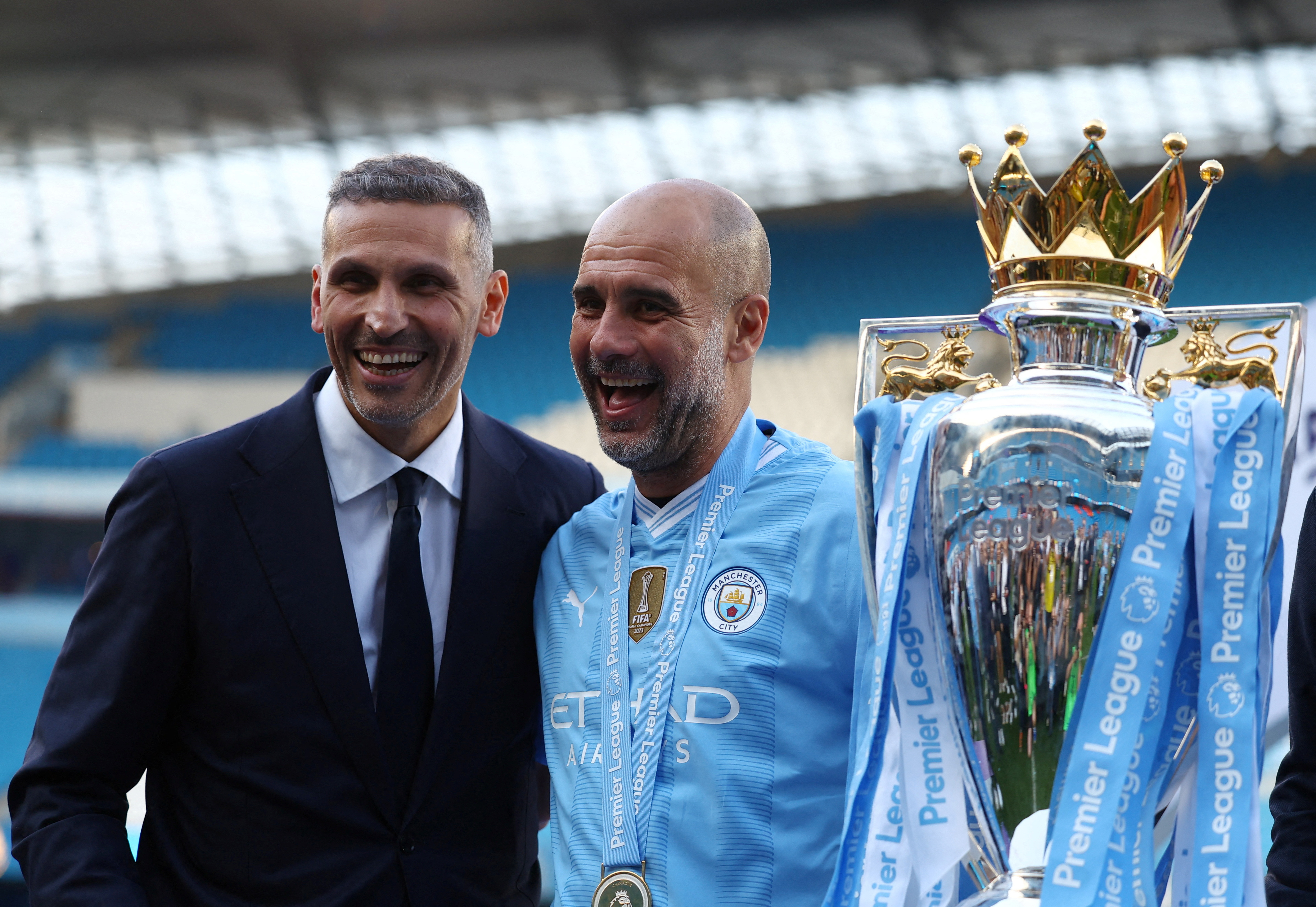 Manchester City manager Pep Guardiola celebrates with chairman Khaldoon Al Mubarak and the trophy after winning the Premier League in 2024