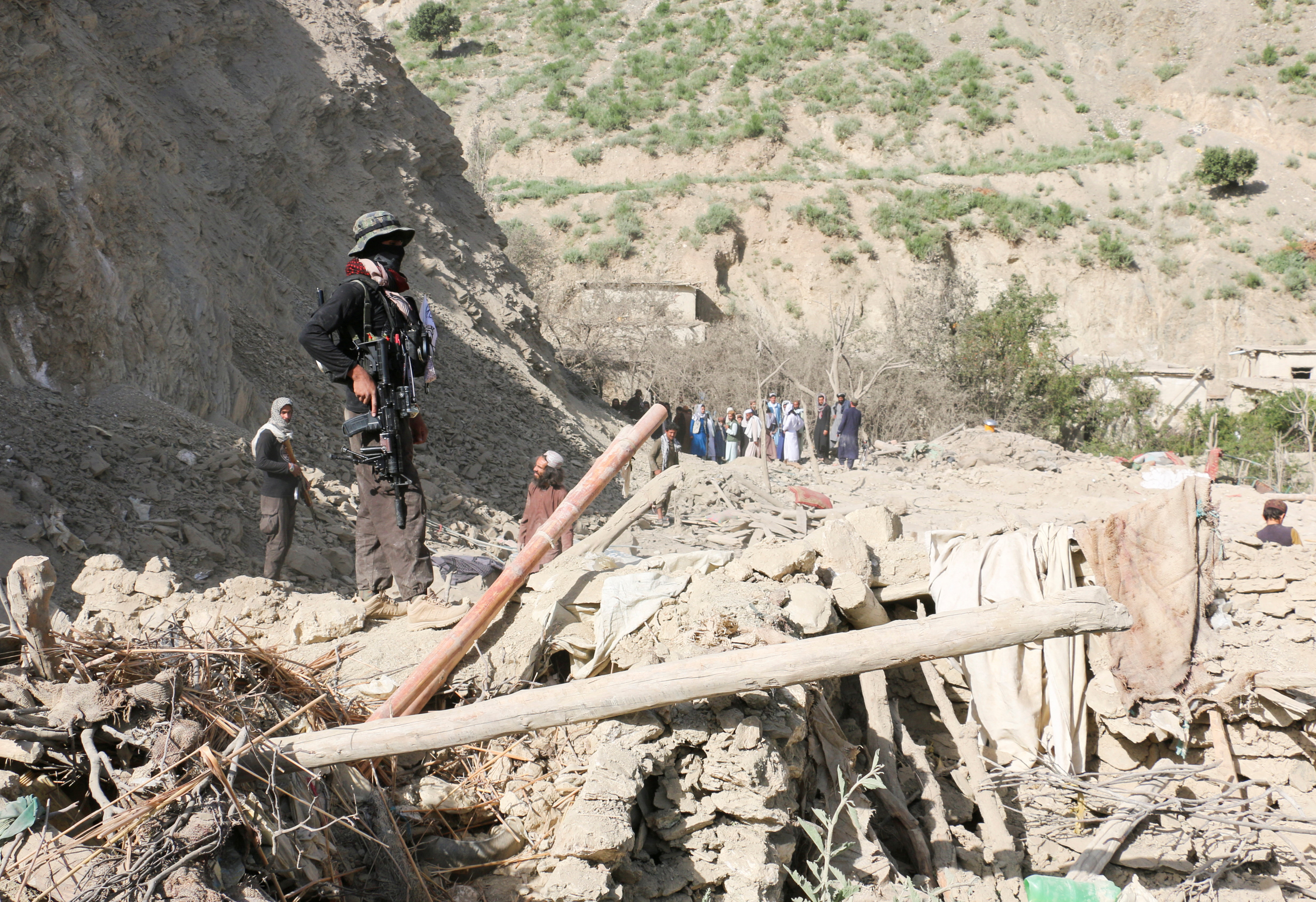 A Taliban security member stands on top of the debris of a house following an airstrike that the Taliban said was carried out by Pakistan in Mani village, Spera District, Khost Province, Afghanistan, June 10, 2026. REUTERS/Stringer