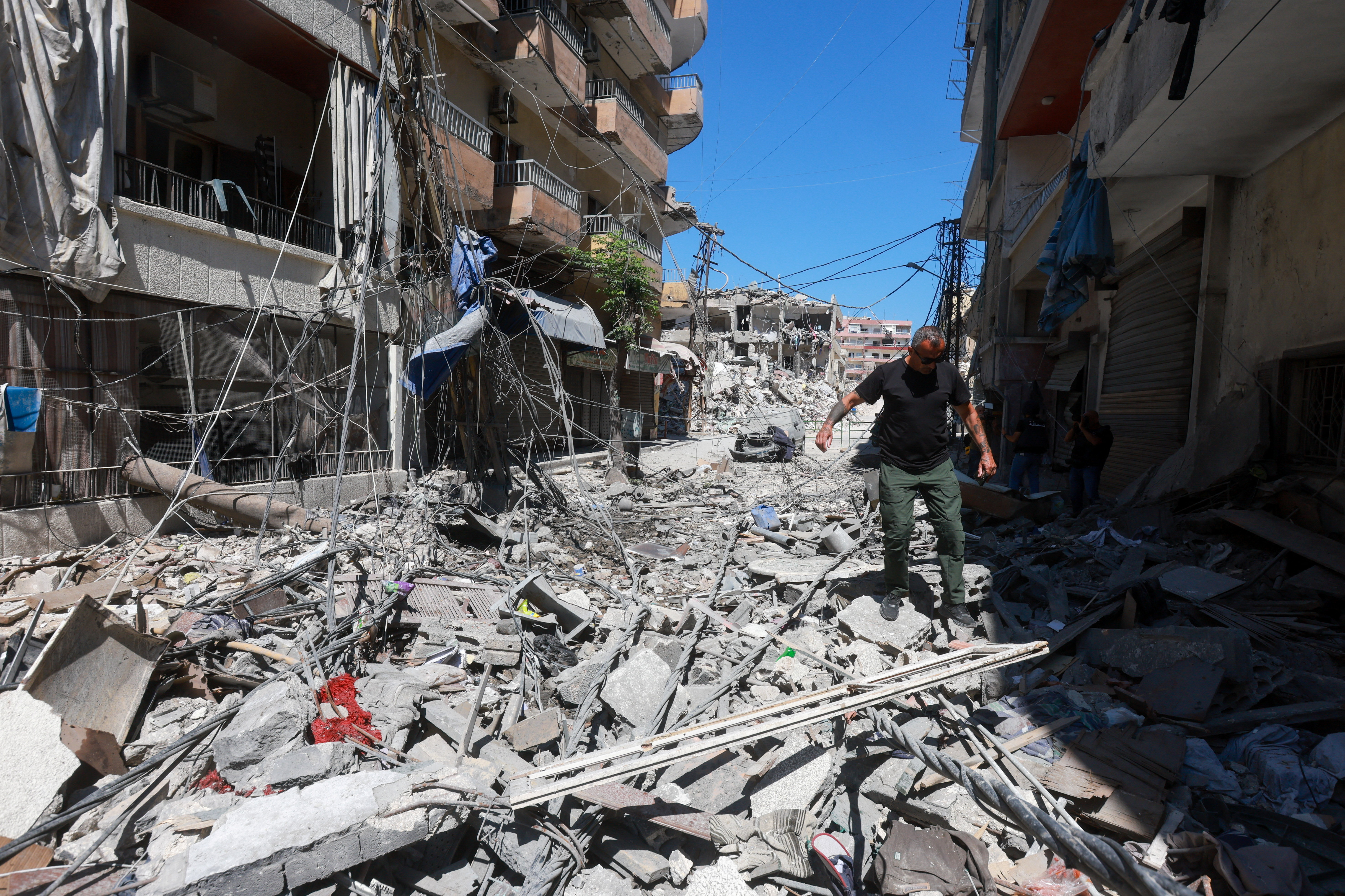 A man walks on rubble at the site an Israeli strike in Tyre, Lebanon, June 12, 2026. REUTERS/Aziz Taher