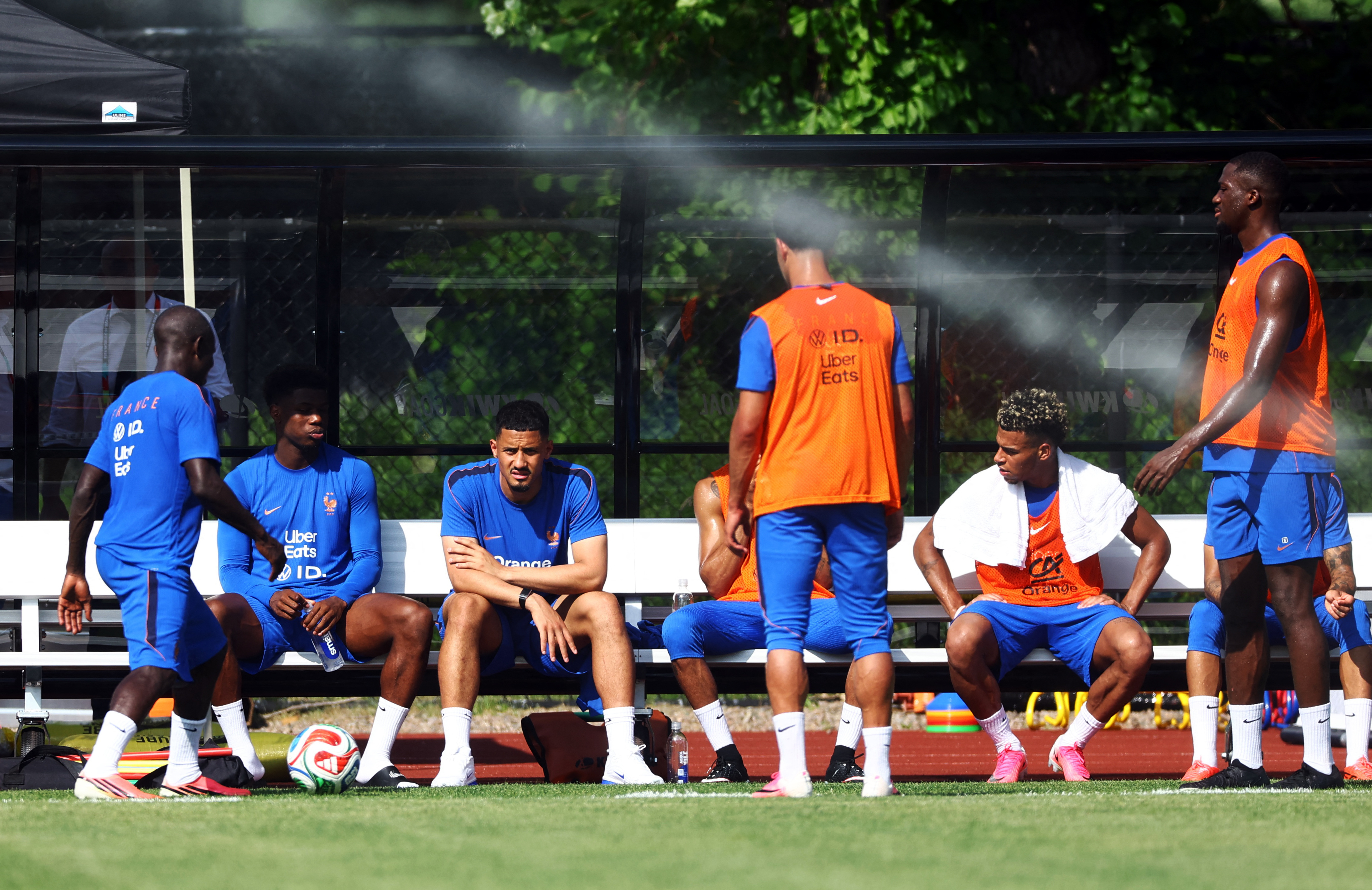 France's William Saliba, Ngolo Kante, Ibrahima Konate and Desire Doue take a seat during training.