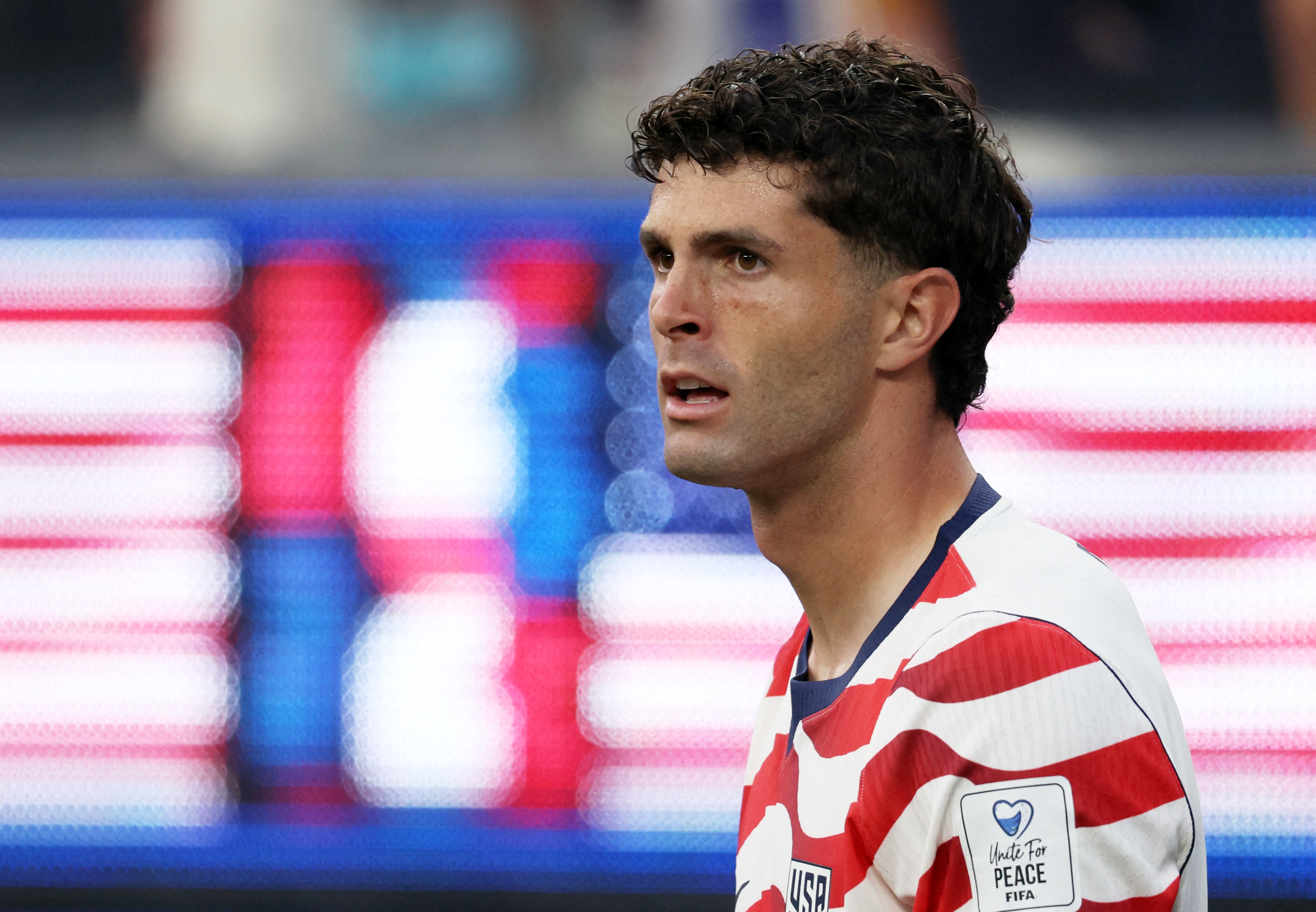 Christian Pulisic of the US looks on.