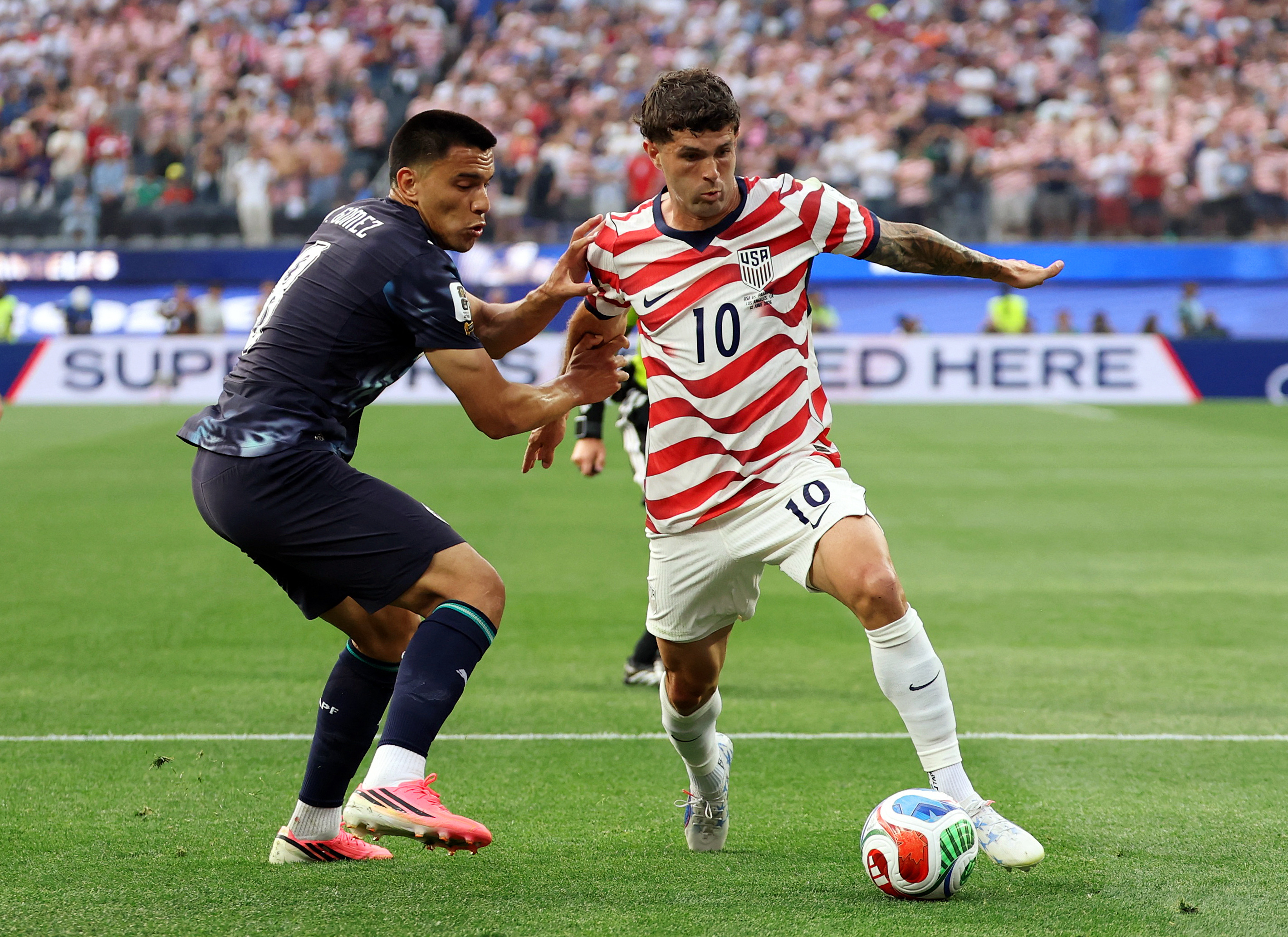 Soccer Football - FIFA World Cup 2026 - Group D - United States v Paraguay - Los Angeles Stadium, Inglewood, California, U.S. - June 12, 2026 Christian Pulisic of the U.S. in action with Paraguay's Diego Gomez IMAGN IMAGES via Reuters/Kiyoshi Mio