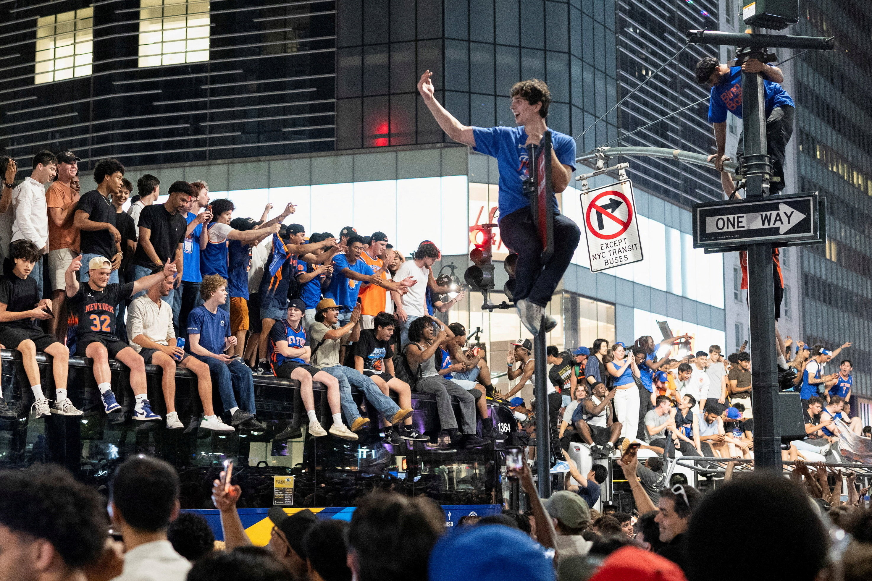 Fans celebrate the New York Knicks' win against the San Antonio Spurs in Game 5 of the NBA Finals, on a street near Madison Square Garden, in New York City, U.S., June 14, 2026. REUTERS/Christian Monterrosa