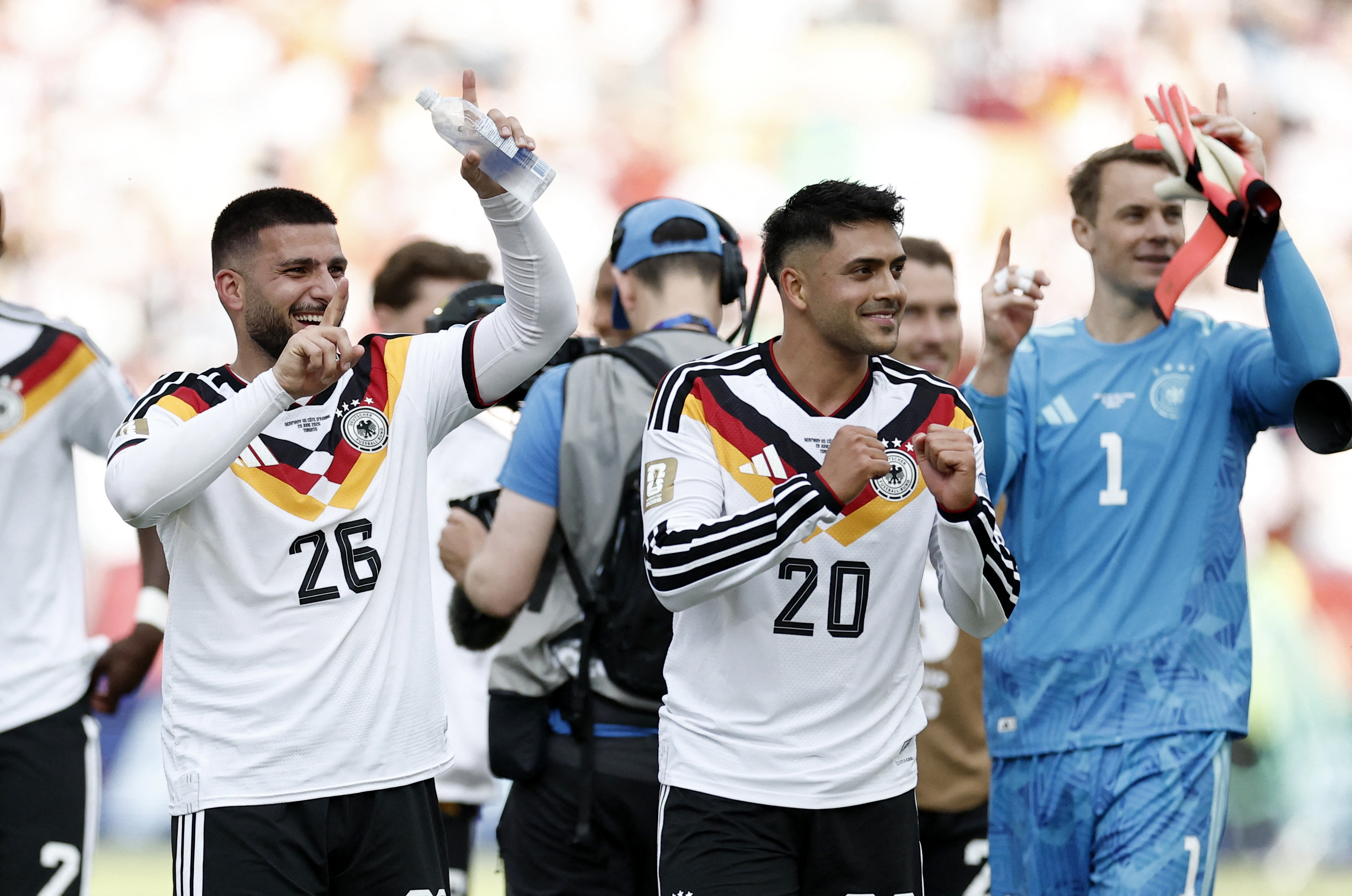 Soccer Football - FIFA World Cup 2026 - Group E - Germany v Ivory Coast - Toronto Stadium, Toronto, Canada - June 20, 2026 Germany's Deniz Undav and Nadiem Amiri celebrate after the match REUTERS/Thomas Mukoya
