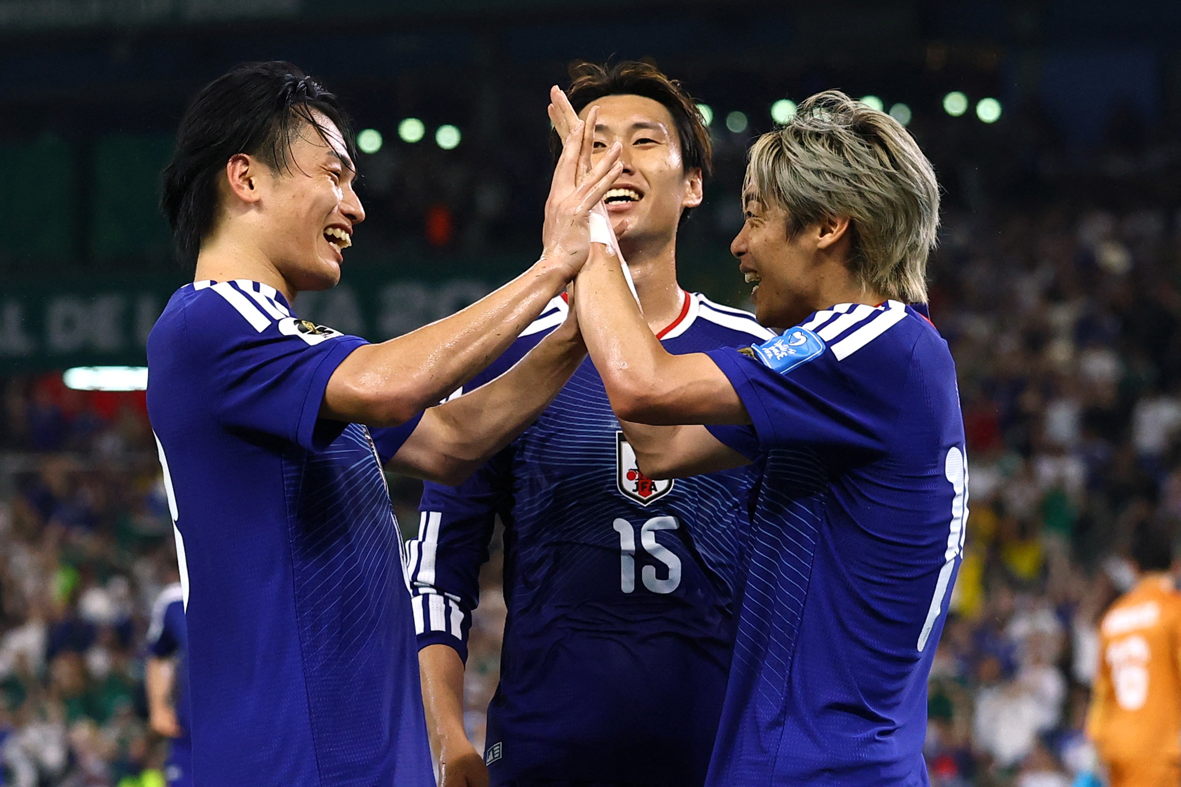 Soccer Football - FIFA World Cup 2026 - Group F - Tunisia v Japan - Estadio Monterrey, Monterrey, Mexico - June 20, 2026 Japan's Junya Ito celebrates scoring their third goal with Japan's Ayase Ueda and Japan's Daichi Kamada REUTERS/Daniel Becerril