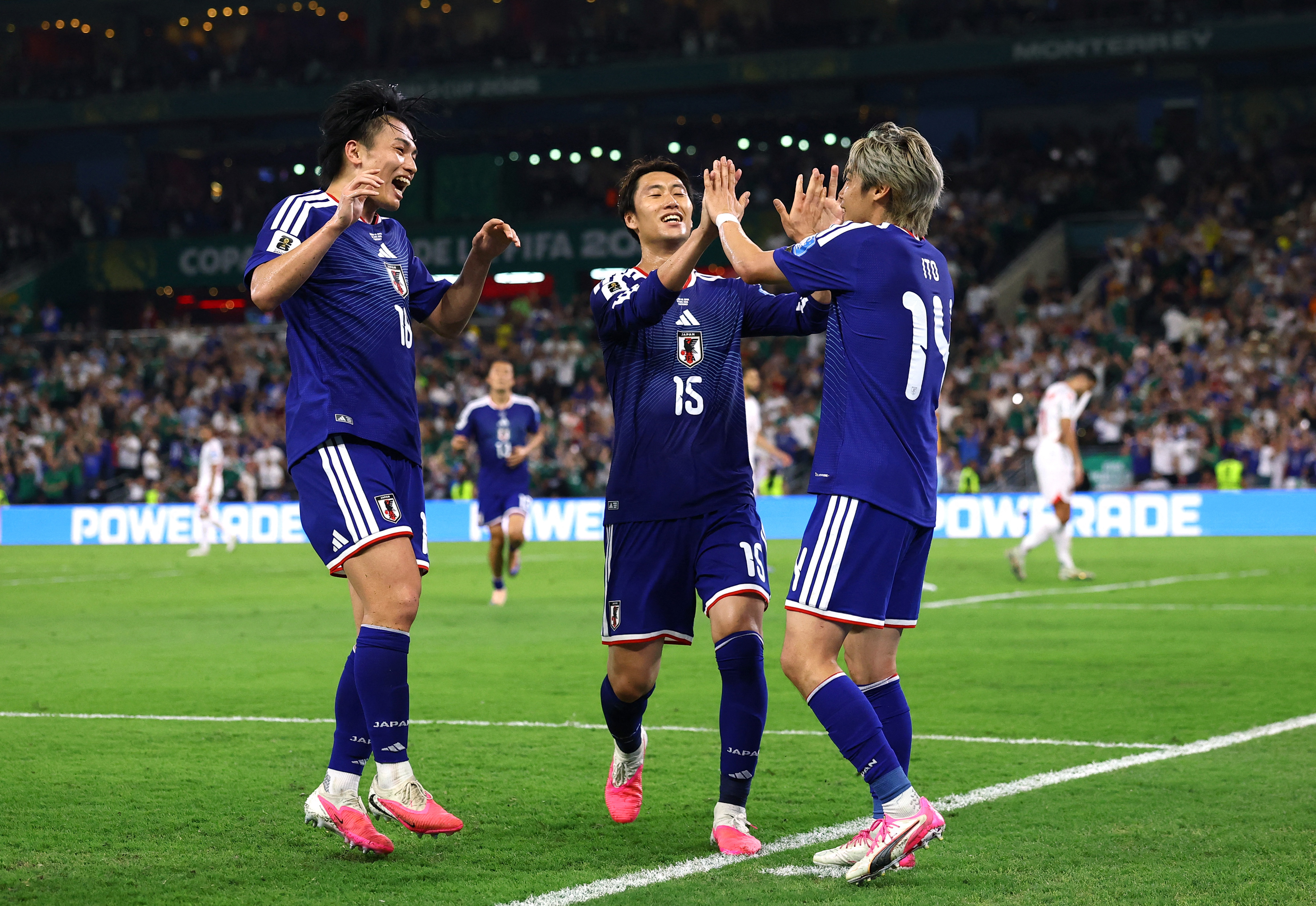 Soccer Football - FIFA World Cup 2026 - Group F - Tunisia v Japan - Estadio Monterrey, Monterrey, Mexico - June 20, 2026 Japan's Junya Ito celebrates scoring their third goal with Japan's Ayase Ueda and Japan's Daichi Kamada REUTERS/Daniel Becerril
