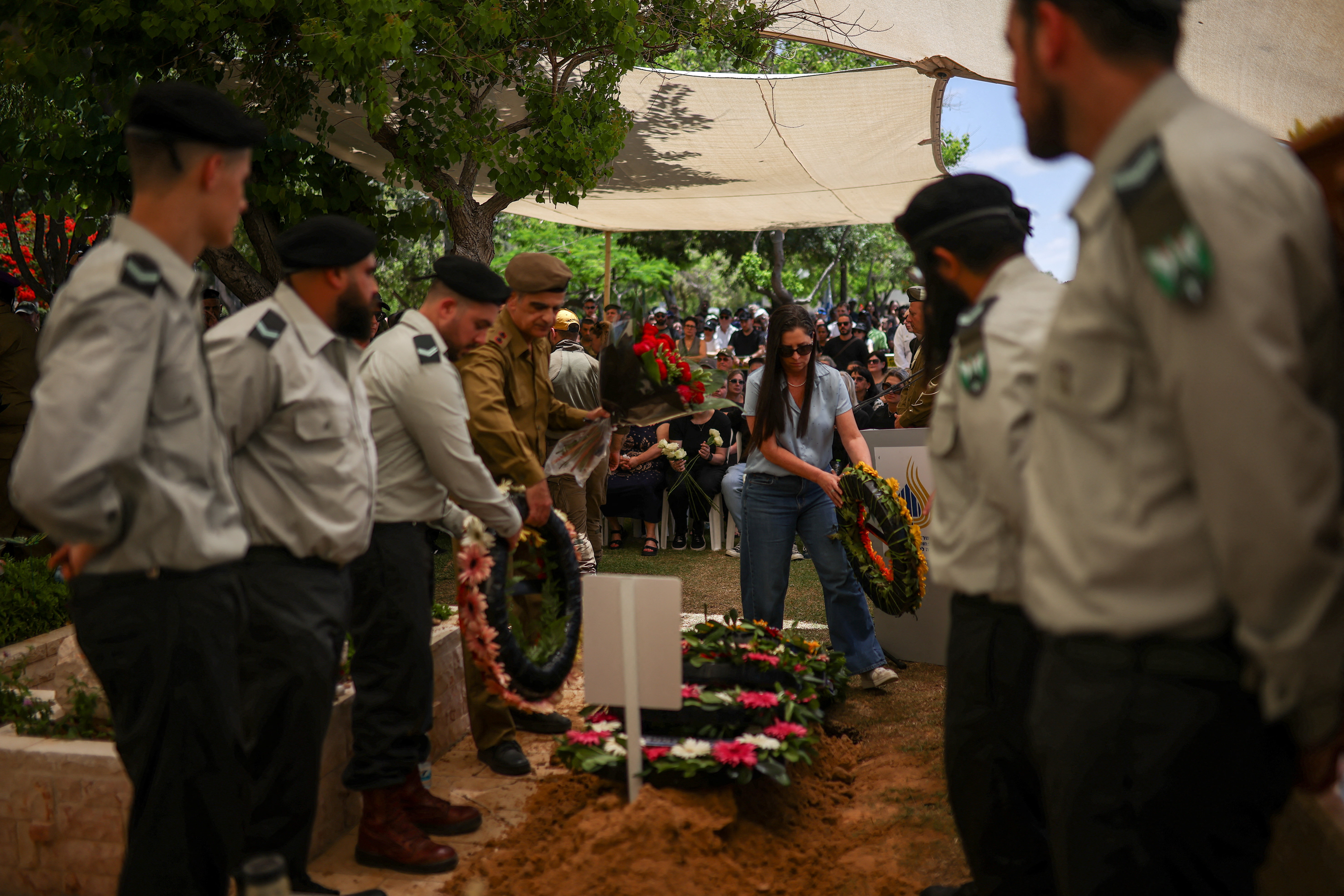 Mourners put wreaths on the grave during the funeral of Israeli soldier Alexander Filin, who, according to the Israeli army, was wounded and later died in an explosive attack by Hezbollah in southern Lebanon, in Haifa, Israel, June 21, 2026