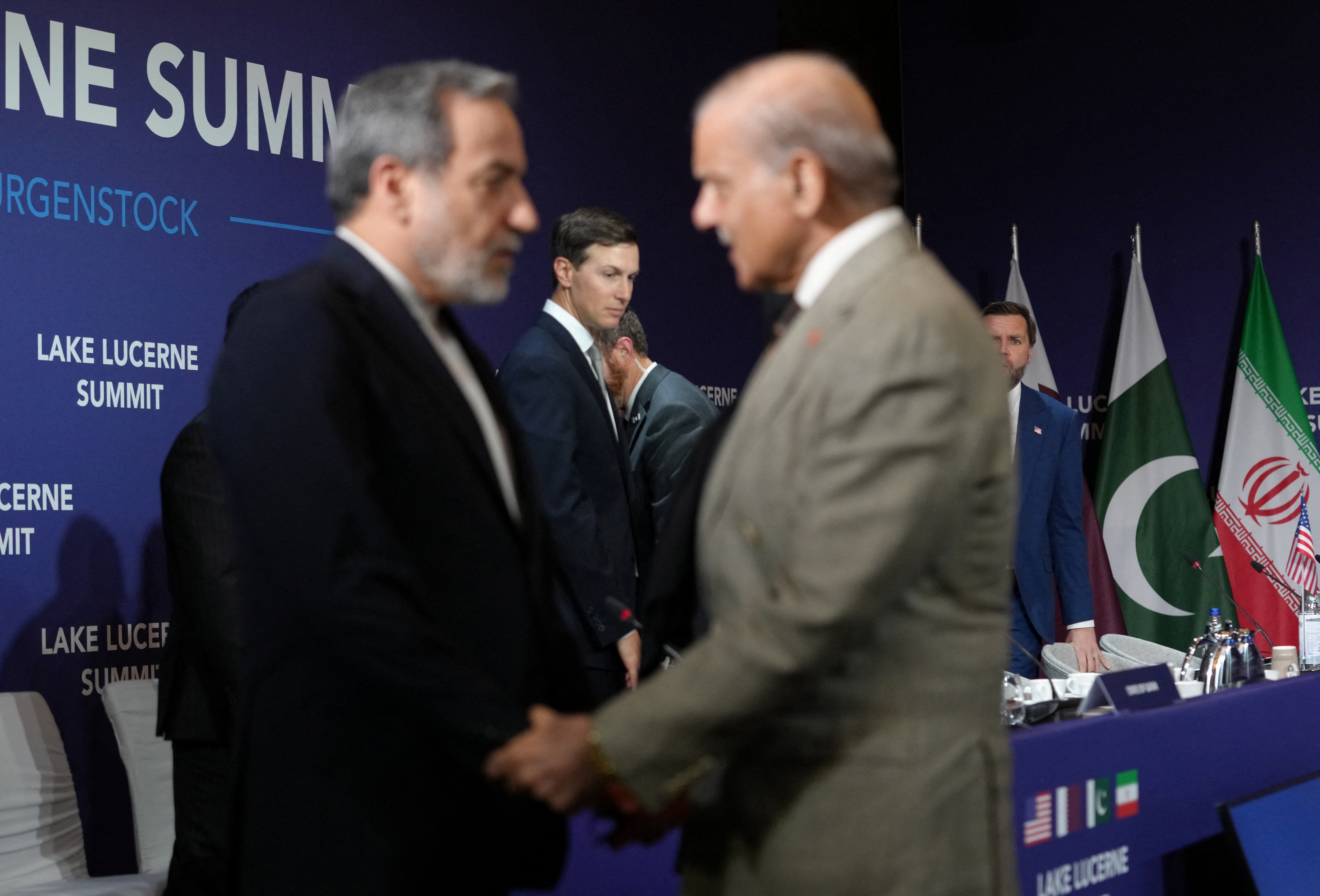 U.S. Vice President JD Vance looks on next to U.S. President Donald Trump's son-in-law Jared Kushner, as Iran's Foreign Minister Abbas Araqchi shakes hands with Pakistan's Prime Minister Shehbaz Sharif, before the start of a quadrilateral meeting between the U.S., Iran, Pakistan, and Qatar at the Lake Lucerne Summit, aimed at advancing a deal to end the Middle East conflict, at Buergenstock Resort Lake Lucerne, near Stansstad, Switzerland, June 21, 2026