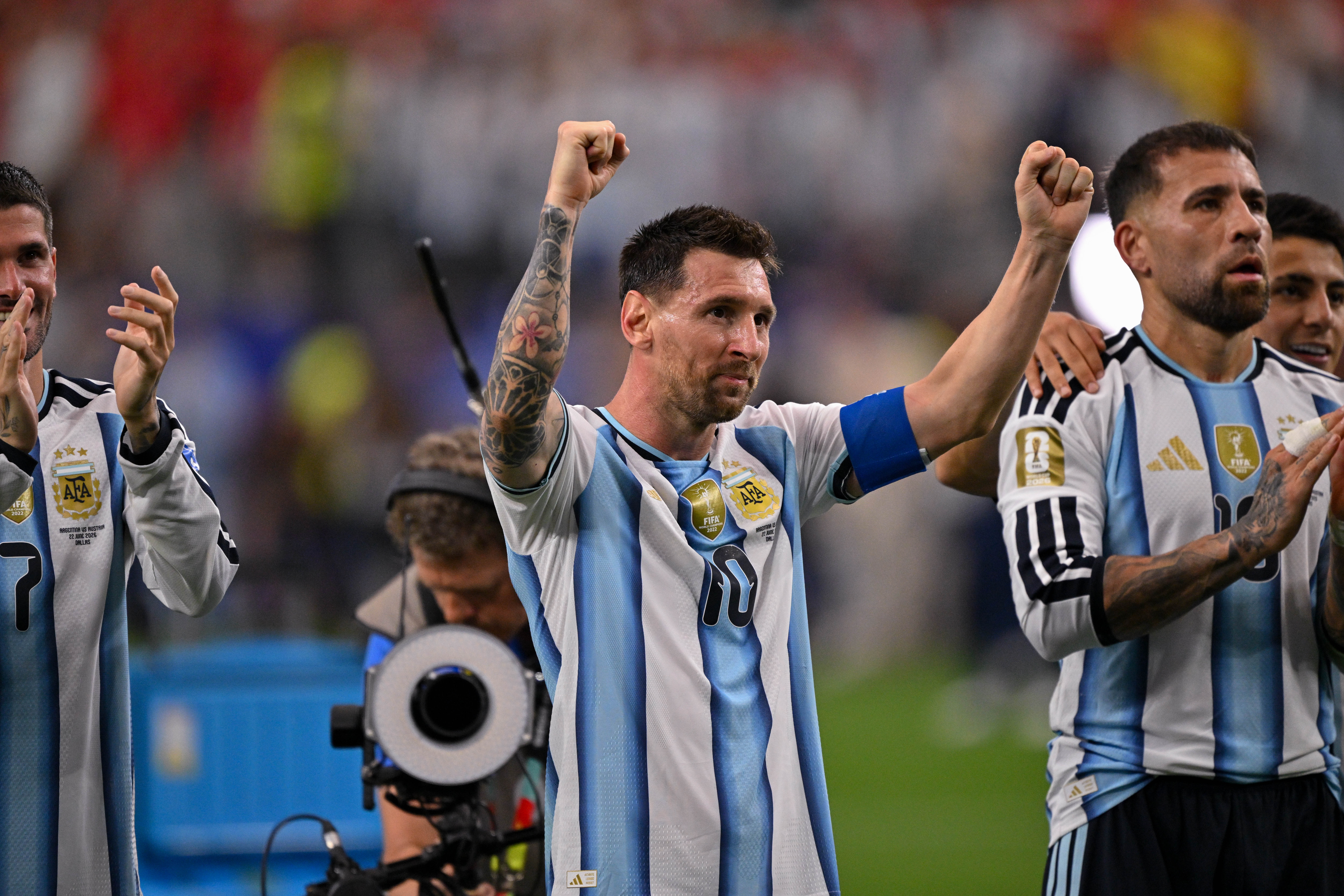 Lionel Messi celebrates Argentina's win over Austria with fans.