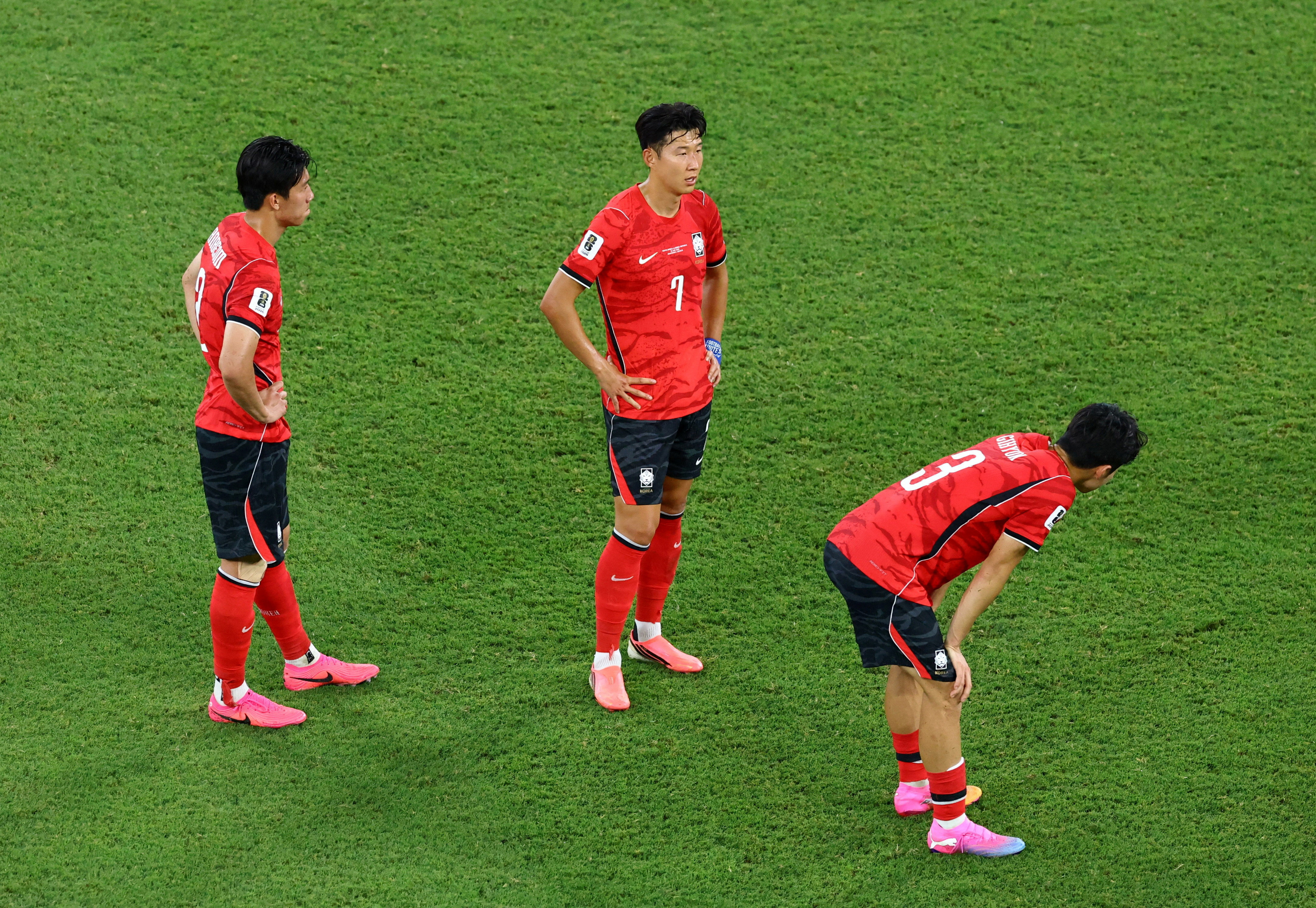 South Korea's players look dejected on the field.