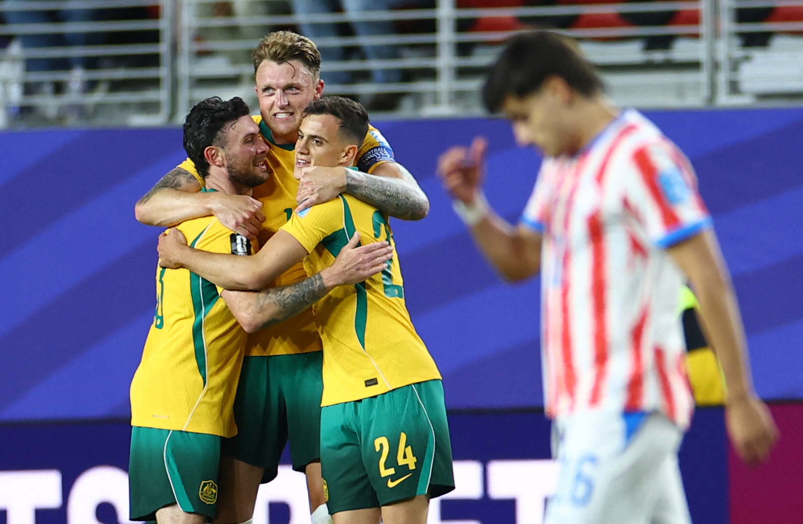 Soccer Football - FIFA World Cup 2026 - Group D - Paraguay v Australia - San Francisco Bay Area Stadium, Santa Clara, California, U.S. - June 25, 2026 Australia's Harry Souttar, Aiden O'Neill and Paul Okon Engstler celebrate after the match REUTERS/Carlos Barria