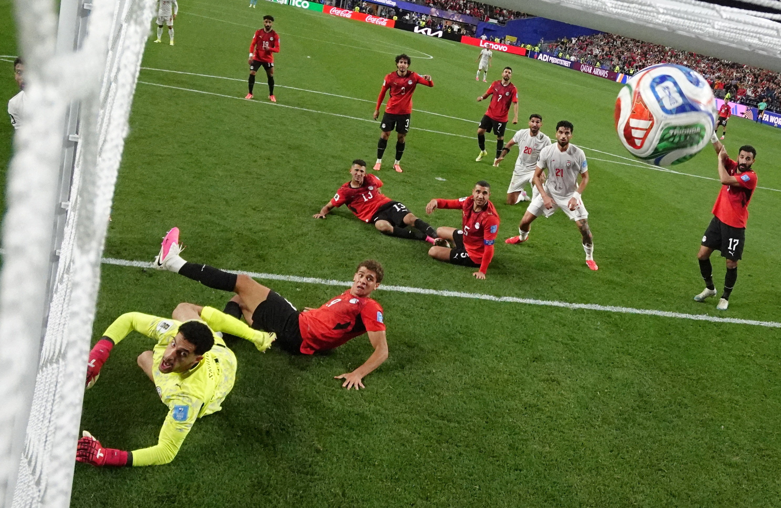 Players look at ball in the air.