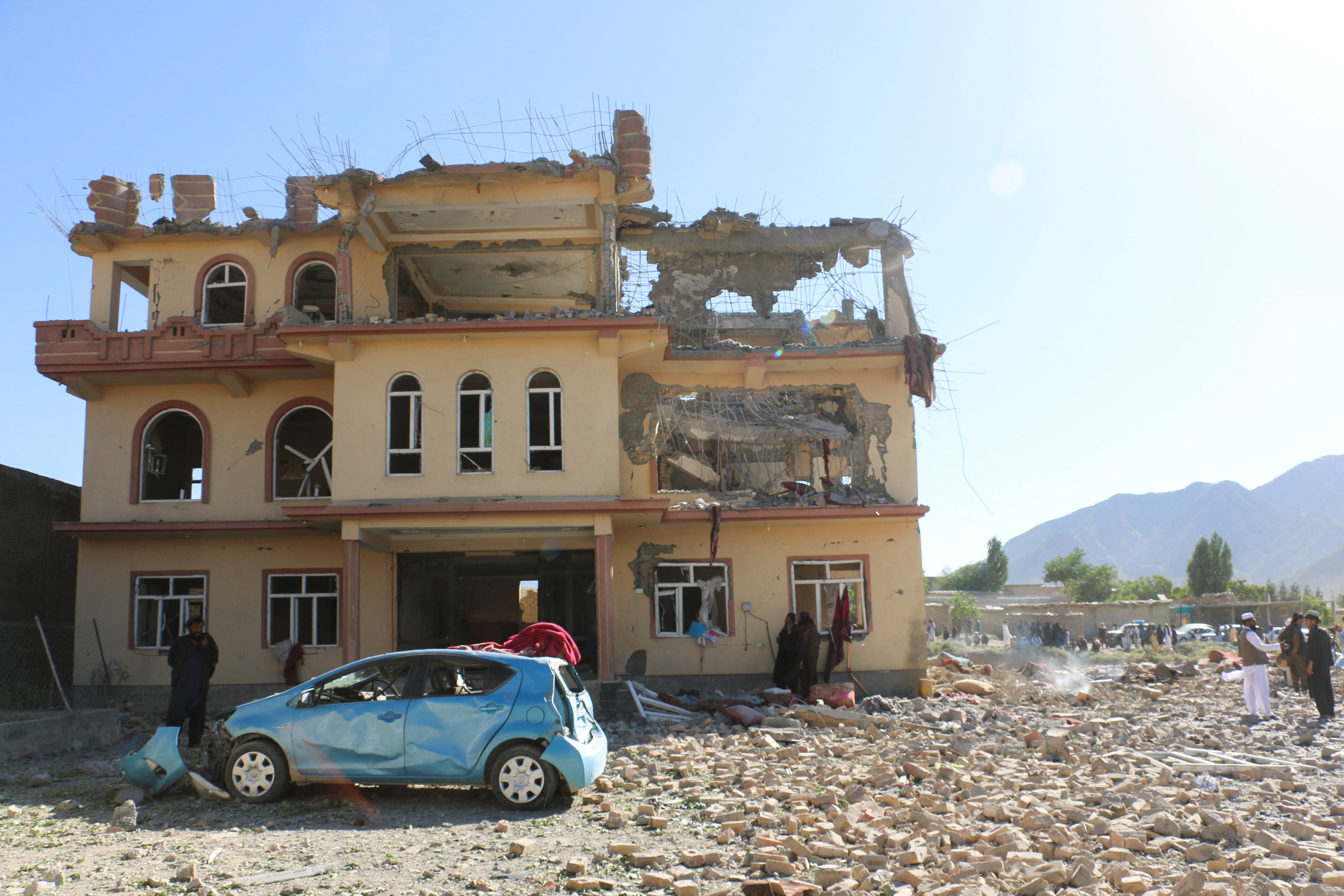 Local residents and Taliban members gather near a destroyed building following an airstrike that the Taliban say was carried out by Pakistan's security forces, in Samkani district, Afghanistan, June 29, 2026. REUTERS/Stringer
