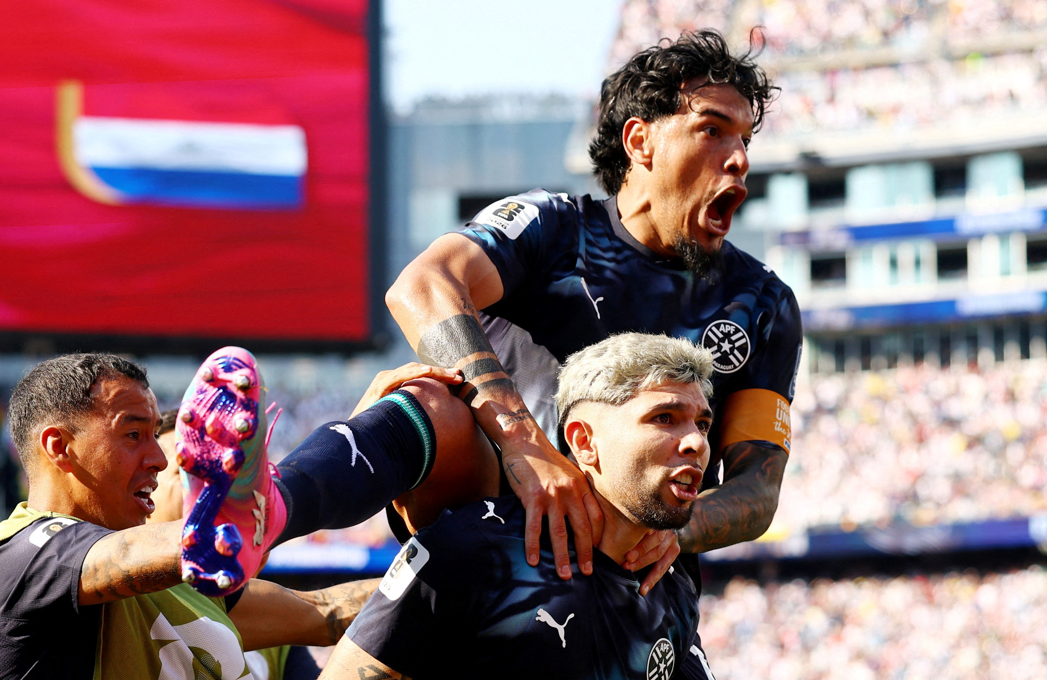 Paraguay's Julio Enciso celebrates scoring their first goal with Gustavo Gomez [Peter Cziborra/Reuters]
