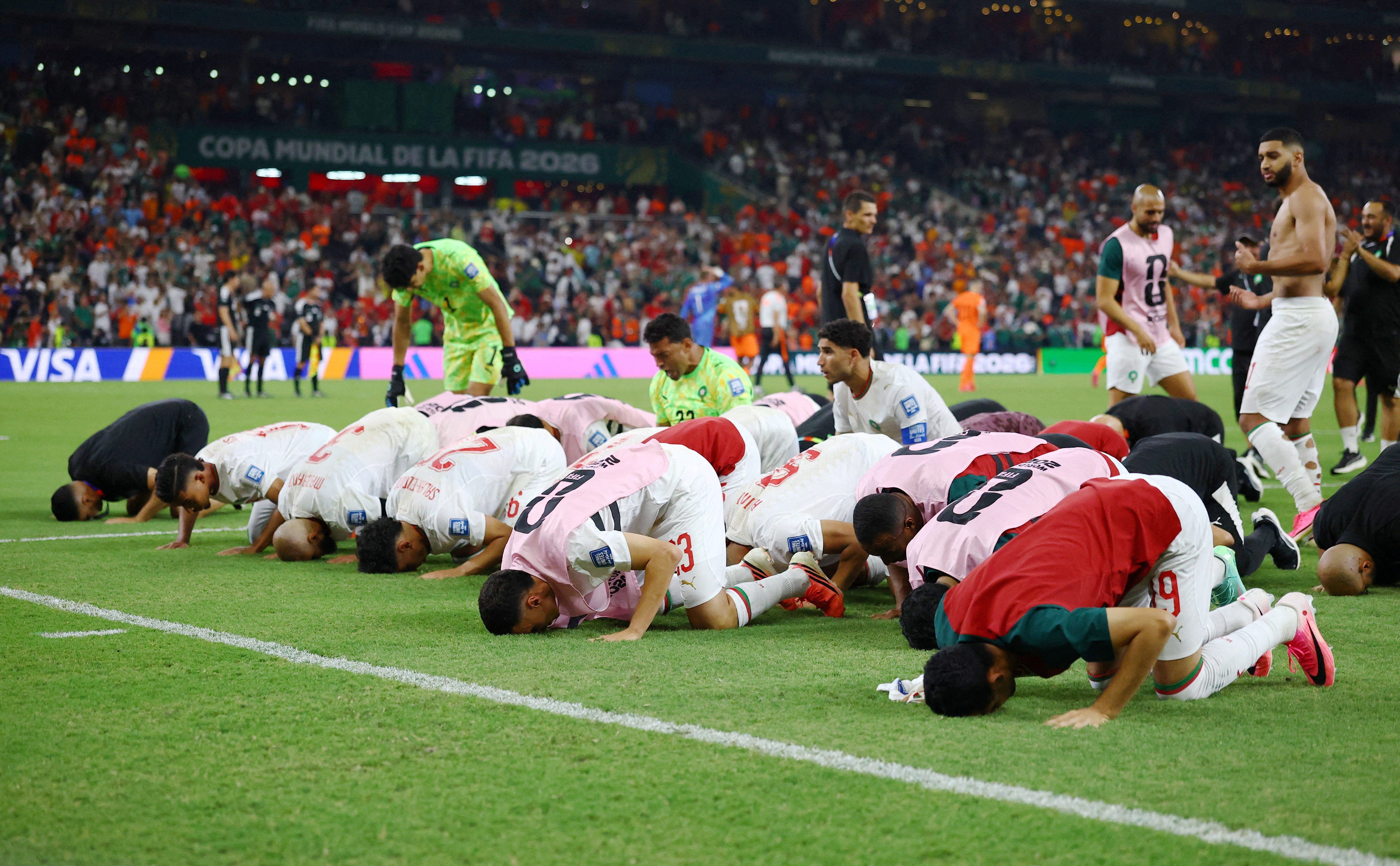 Morocco players celebrate after the penalty shootout as Morocco qualify for the round of 16 stage of the World Cup