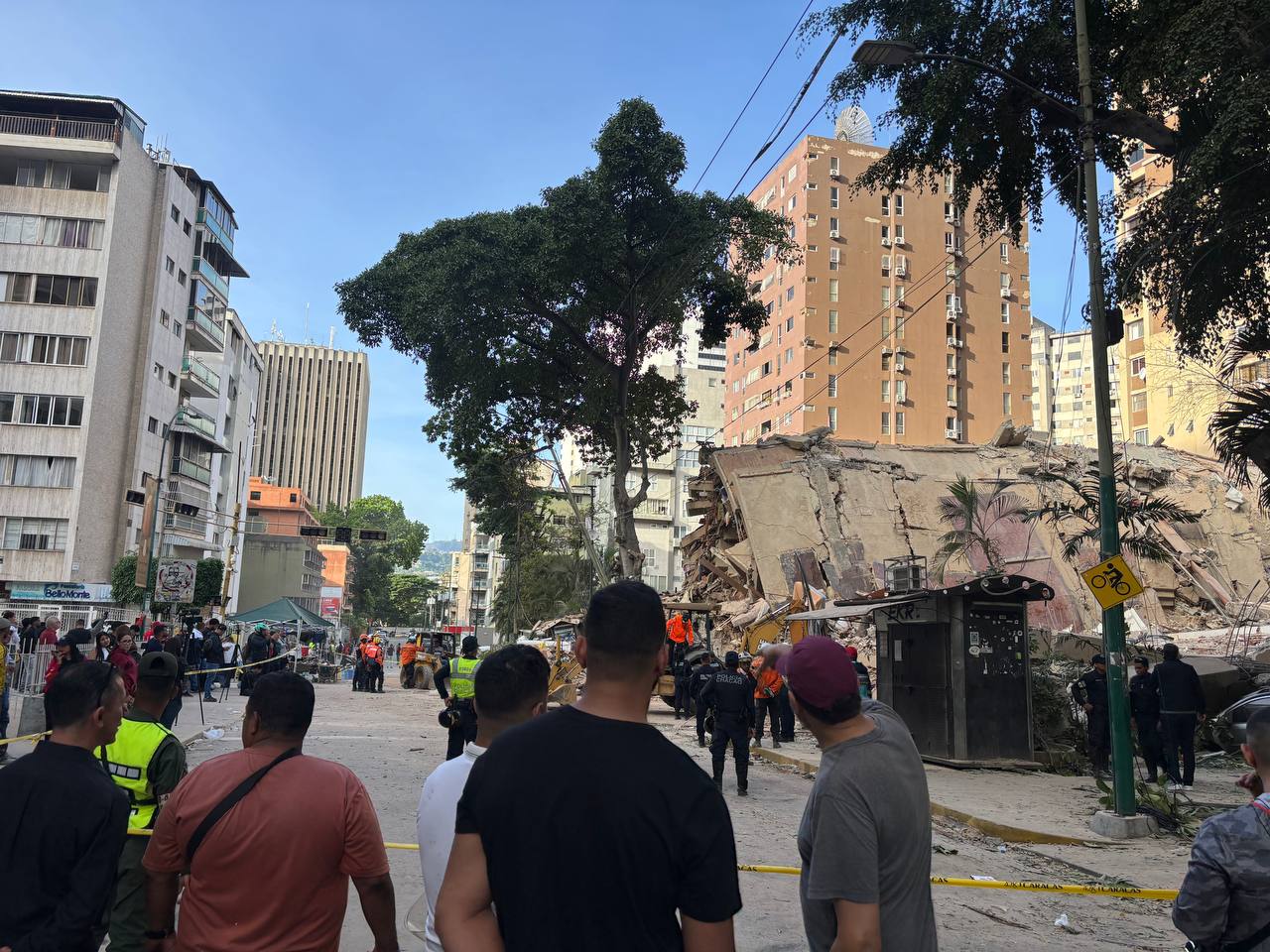residents survey a collapsed building following an earthquake