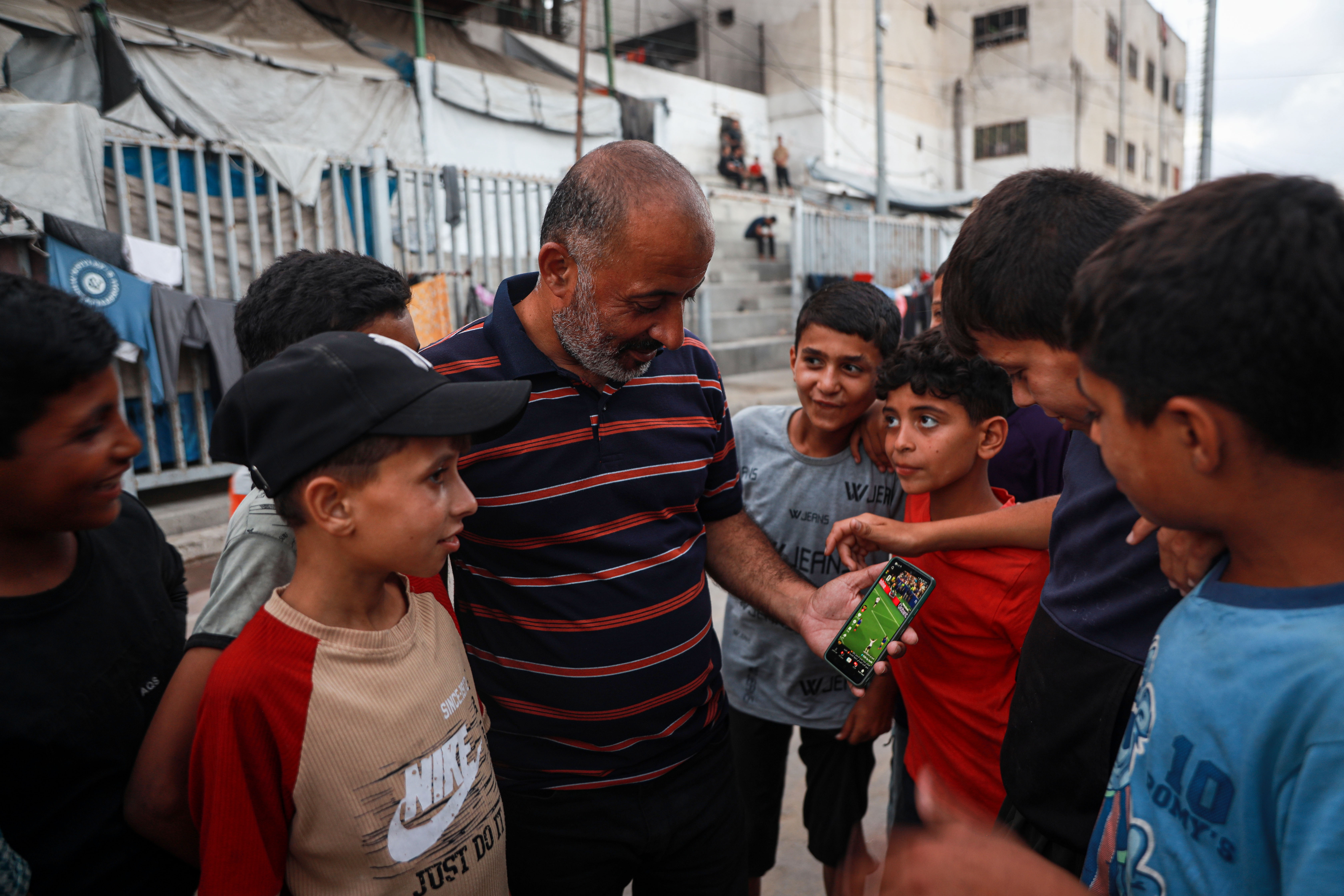 Samih Totah, 43, is unable to follow matches live due to harsh living conditions and instead relies on match highlights. [Abdelhakim Abu Riash/ Al Jazeera] 