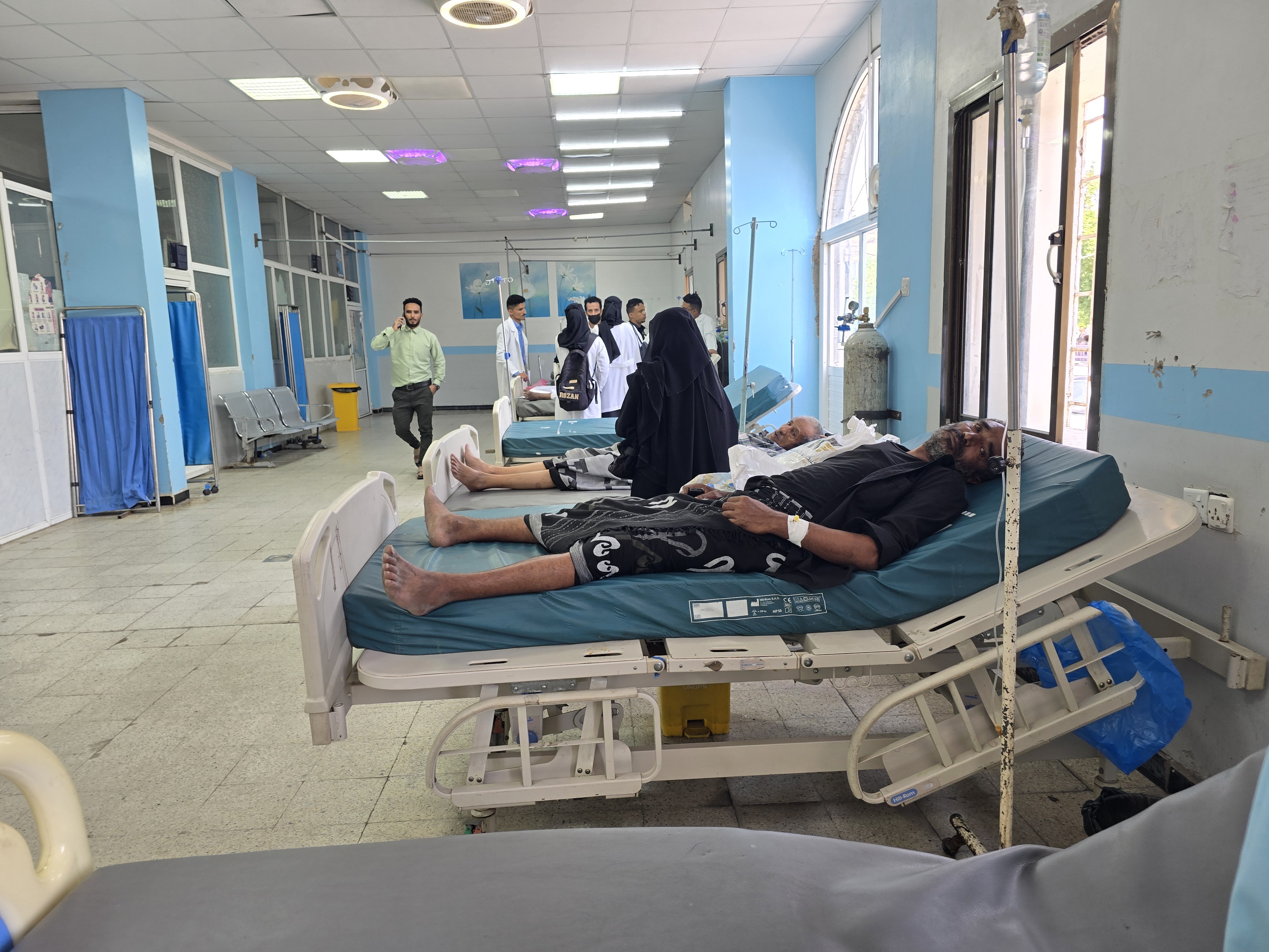 patients on beds in hospital ward