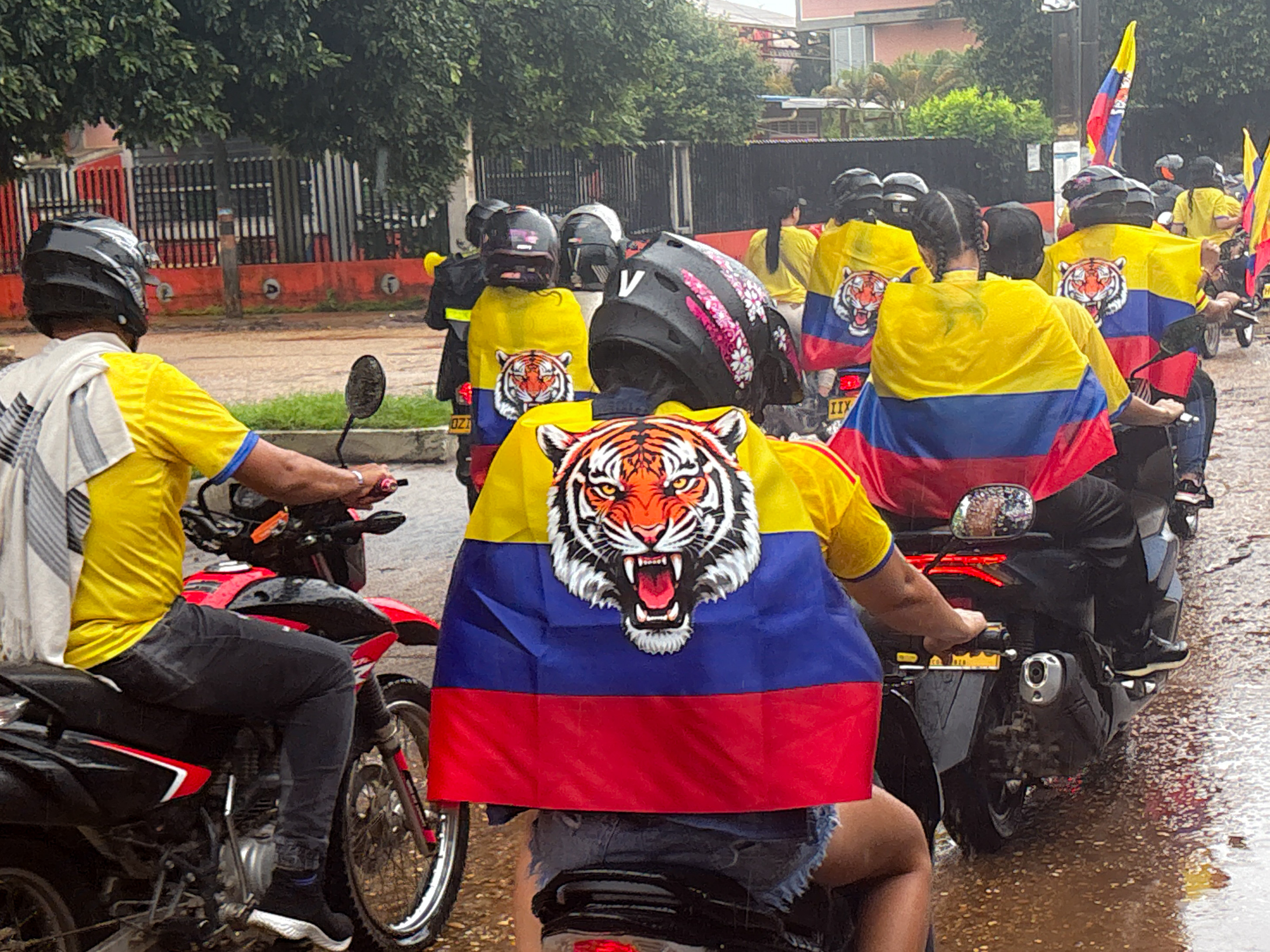 Caravan of De La Espriella supporters ride motorbikes and wear flags with tigers on their backs.