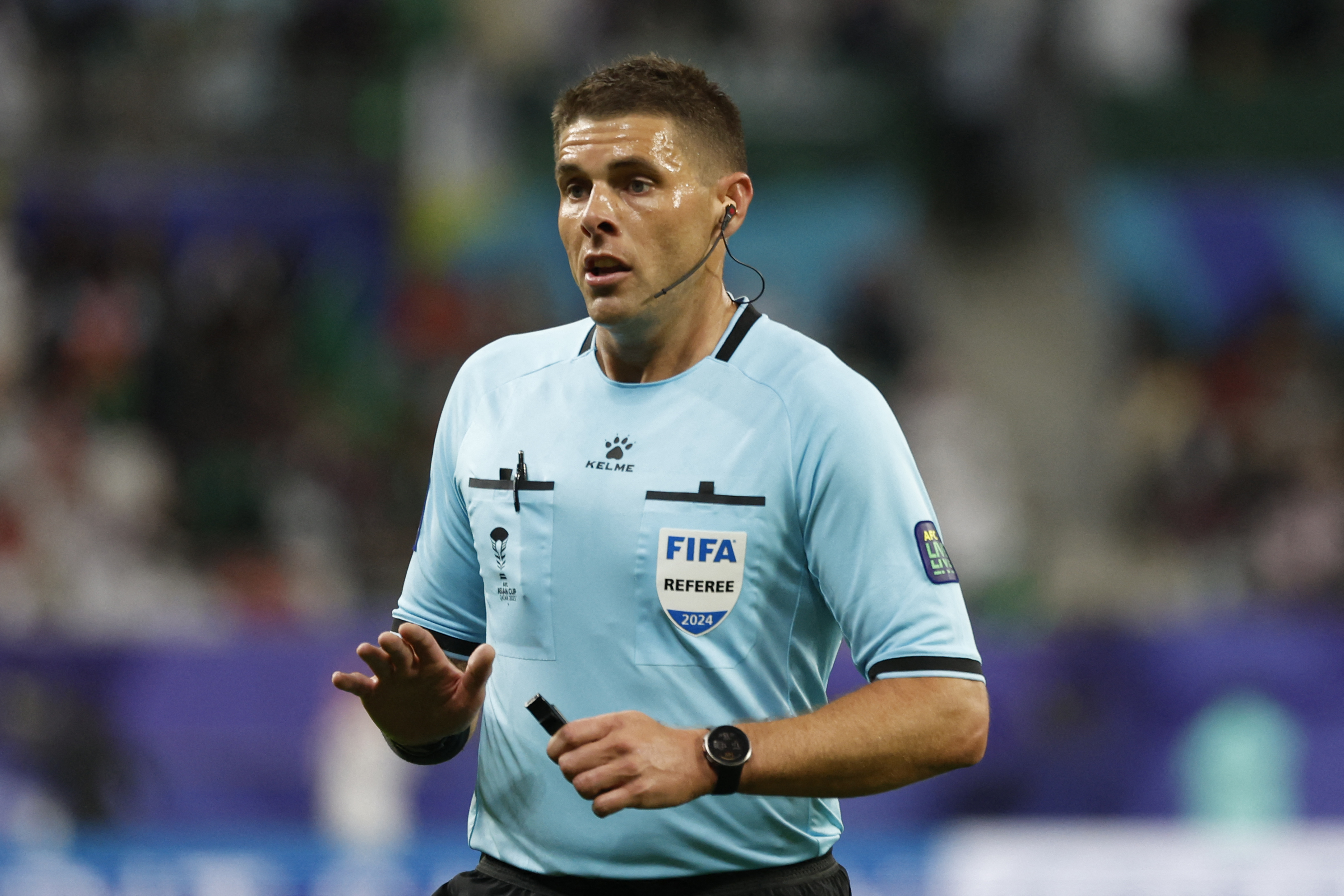 Australian referee Shaun Evans gestures during the Qatar 2023 AFC Asian Cup Group F football match between Saudi Arabia and Oman at the Khalifa International Stadium in Doha on January 16, 2024. (Photo by KARIM JAAFAR / AFP)